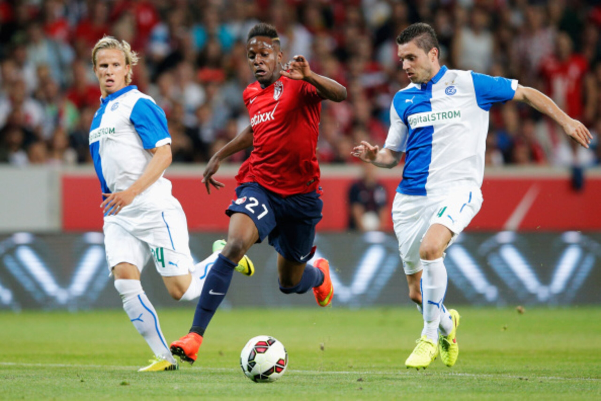 LILLE, FRANCE - AUGUST 05:  Divock Origi of Lille battles for the ball with Sanel Jahic and Moritz Bauer of Grasshopper during the UEFA Champions League third qualifying round 2nd leg match between LOSC Lille and Grasshopper Club Zurich at the Stade Pierr