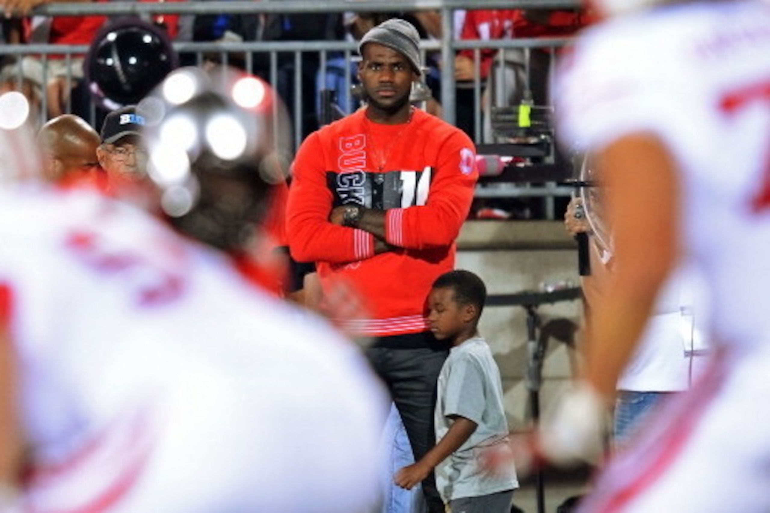 COLUMBUS, OH - SEPTEMBER 28:  NBA player LeBron James watches from the sidelines as the Ohio State Buckeyes play the Wisconsin Badgers at Ohio Stadium on September 28, 2013 in Columbus, Ohio.  (Photo by Jamie Sabau/Getty Images)