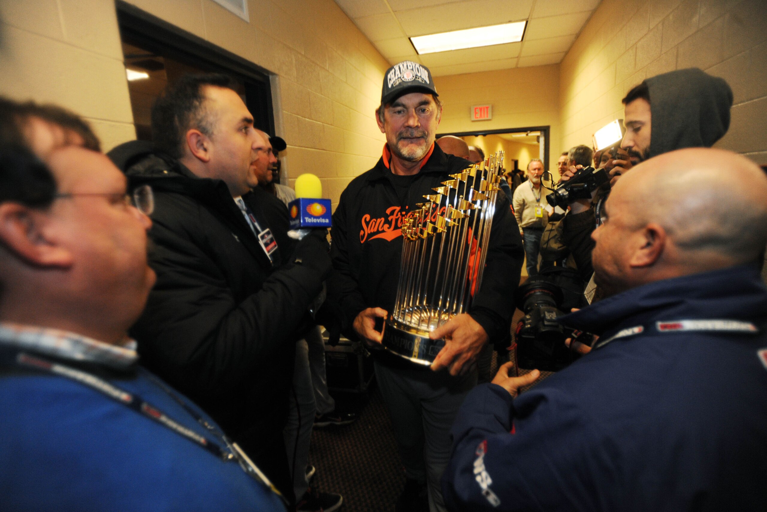 Oct 28, 2012; Detroit, MI, USA; San Francisco Giants manager Bruce Bochy (middle) holds the commissioner's trophy after game four of the 2012 World Series against the Detroit Tigers at Comerica Park.  The Giants won 4-3 to sweep the series. Mandatory Cred