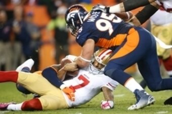 Oct 19, 2014; Denver, CO, USA; San Francisco 49ers quarterback Colin Kaepernick (7) is sacked by Denver Broncos outside linebacker Von Miller (58) and defensive end Derek Wolfe (95) in the fourth quarter at Sports Authority Field at Mile High. Mandatory C