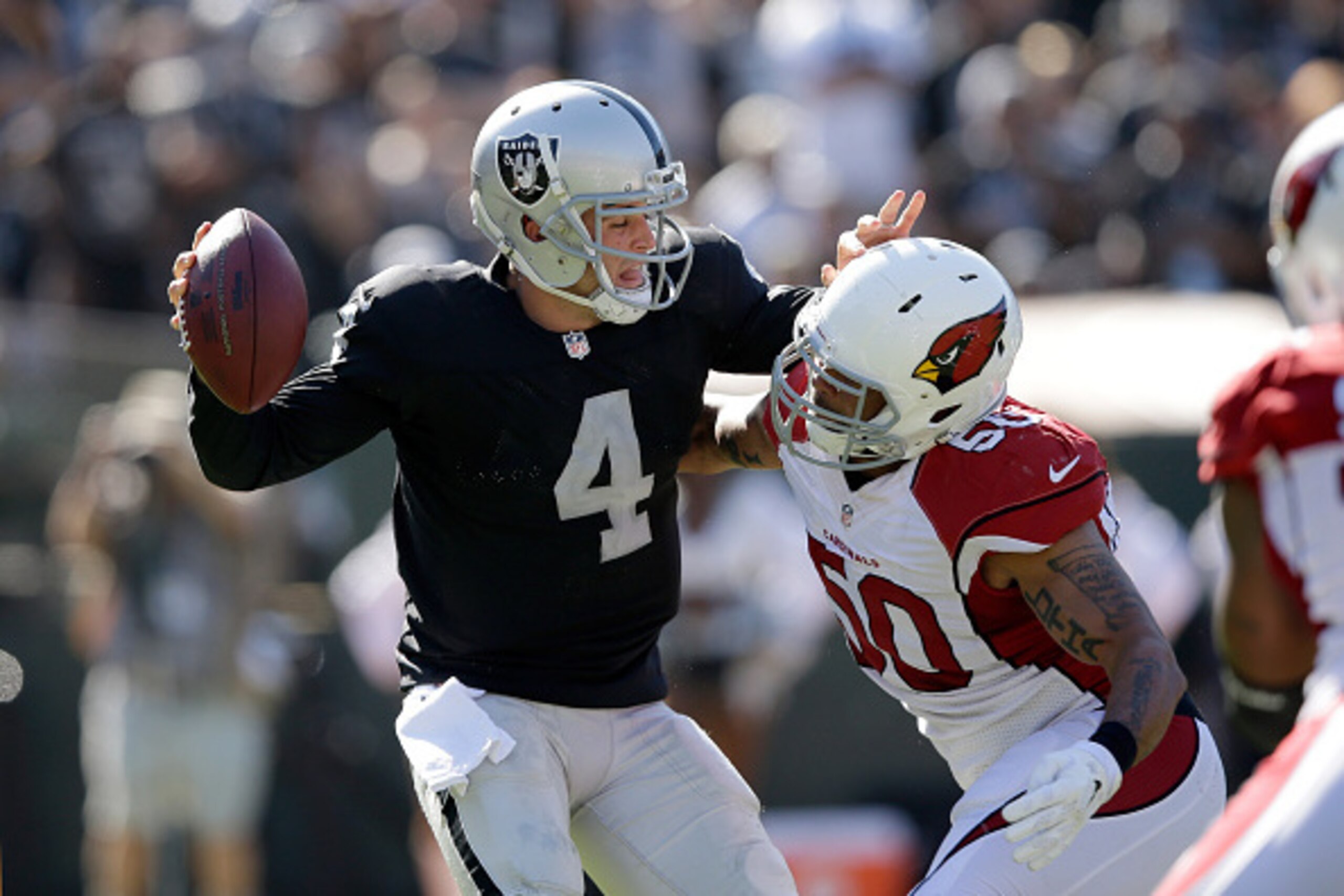 OAKLAND, CA - OCTOBER 19:  Derek Carr #4 of the Oakland Raiders is sacked by Larry Foote #50 of the Arizona Cardinals at O.co Coliseum on October 19, 2014 in Oakland, California.  (Photo by Ezra Shaw/Getty Images)