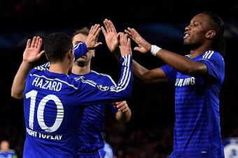 LONDON, ENGLAND - OCTOBER 21:  Eden Hazard #10 of Chelsea is congratulated by teammate Didier Drogba after his cross is deflected for an own goal by Mitja Viler of Maribor during the UEFA Champions League Group G match between Chelsea FC and NK Maribor at