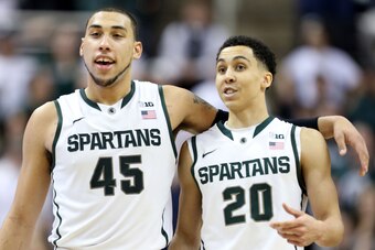 Mar 6, 2014; East Lansing, MI, USA; Michigan State Spartans guard Denzel Valentine (45) and Michigan State Spartans guard Travis Trice (20) celebrate their win over Iowa Hawkeyes during the 2nd half of a game at Jack Breslin Student Events Center. MSU won
