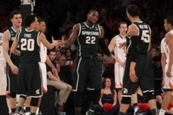Mar 28, 2014; New York, NY, USA; Michigan State Spartans guard/forward Branden Dawson (22) celebrates with guard Travis Trice (20) and guard Denzel Valentine (45) during the first half against the Virginia Cavaliers in the semifinals of the east regional