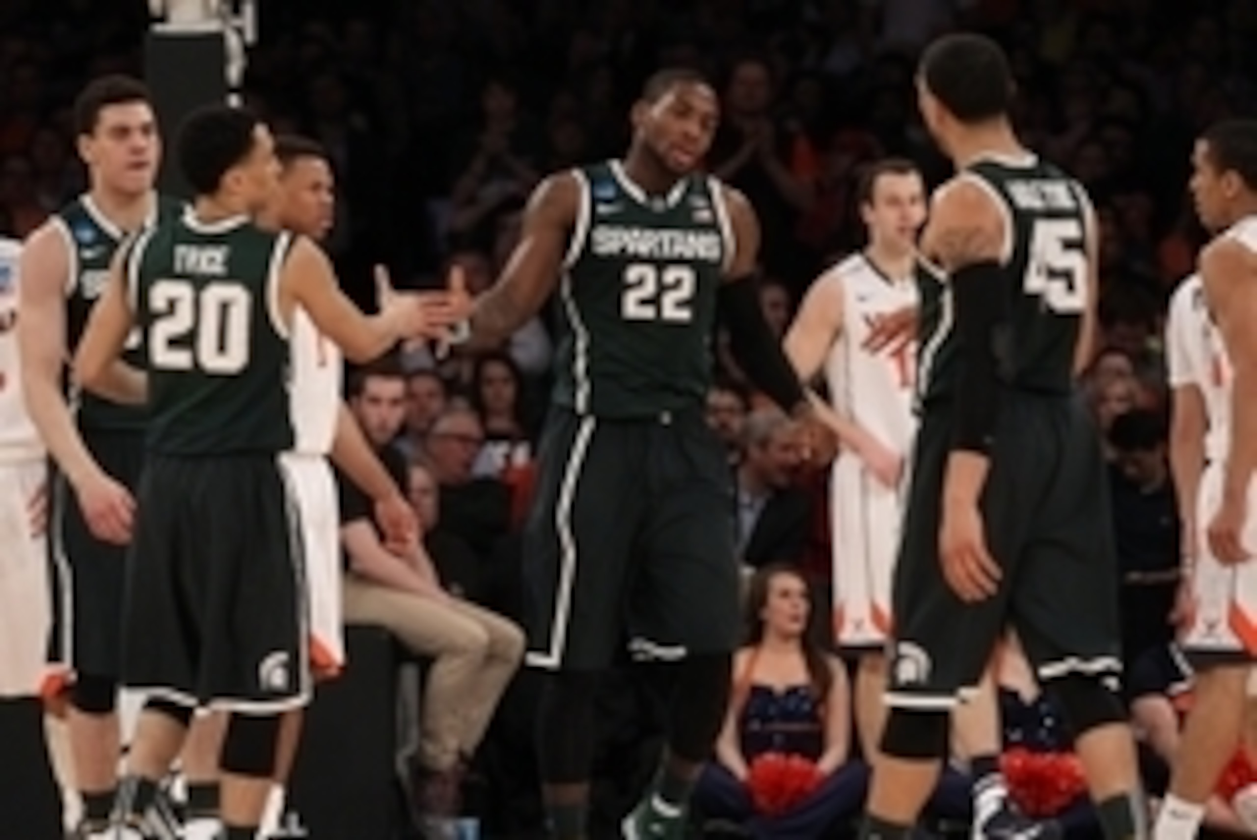 Mar 28, 2014; New York, NY, USA; Michigan State Spartans guard/forward Branden Dawson (22) celebrates with guard Travis Trice (20) and guard Denzel Valentine (45) during the first half against the Virginia Cavaliers in the semifinals of the east regional