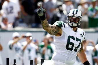 EAST RUTHERFORD, NJ - SEPTEMBER 07:   Brian Winters #67 of the New York Jets is introduced before a game against the Oakland Raiders at MetLife Stadium on September 7, 2014 in East Rutherford, New Jersey.  (Photo by Jeff Zelevansky/Getty Images)