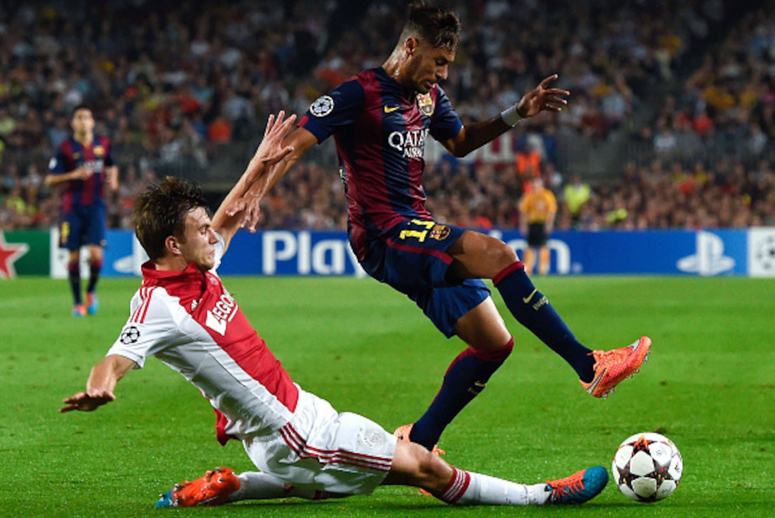 BARCELONA, SPAIN - OCTOBER 21:  Neymar of FC Barcelona competes for the ball with Joel Veltman of AFC Ajax during a UEFA Champions League Group F match between FC Barcelona and AFC Ajax at the Camp Nou Stadium on October 21, 2014 in Barcelona, Spain.  (Ph