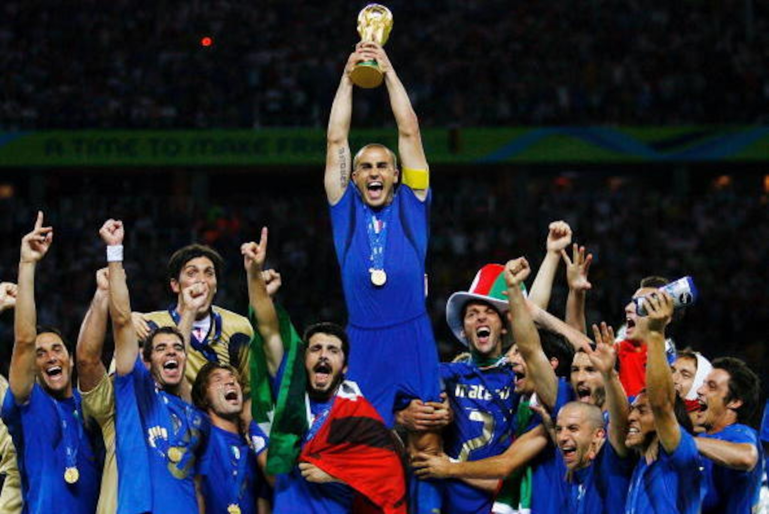 BERLIN - JULY 09:  The Italian players celebrate as Fabio Cannavaro of Italy lifts the World Cup trophy aloft following victory in a penalty shootout at the end of the FIFA World Cup Germany 2006 Final match between Italy and France at the Olympic Stadium