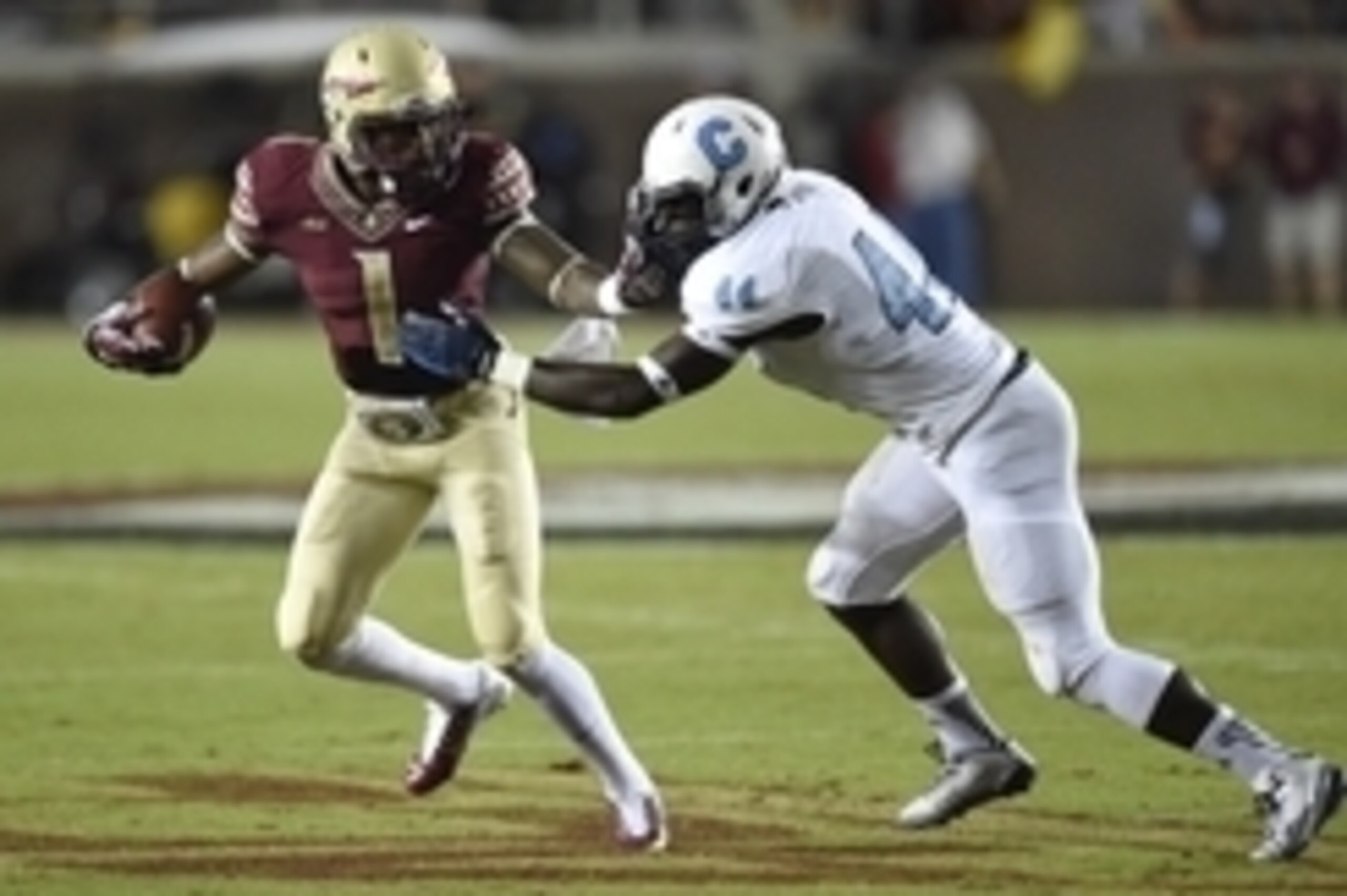 Sep 6, 2014; Tallahassee, FL, USA;  Florida State Seminoles wide receiver Ermon Lane (1) fends off Citadel Bulldogs linebacker Israel Battle (44) during the third quarter at Doak Campbell Stadium. Florida State defeated Citadel 37-12. Mandatory Credit: Jo