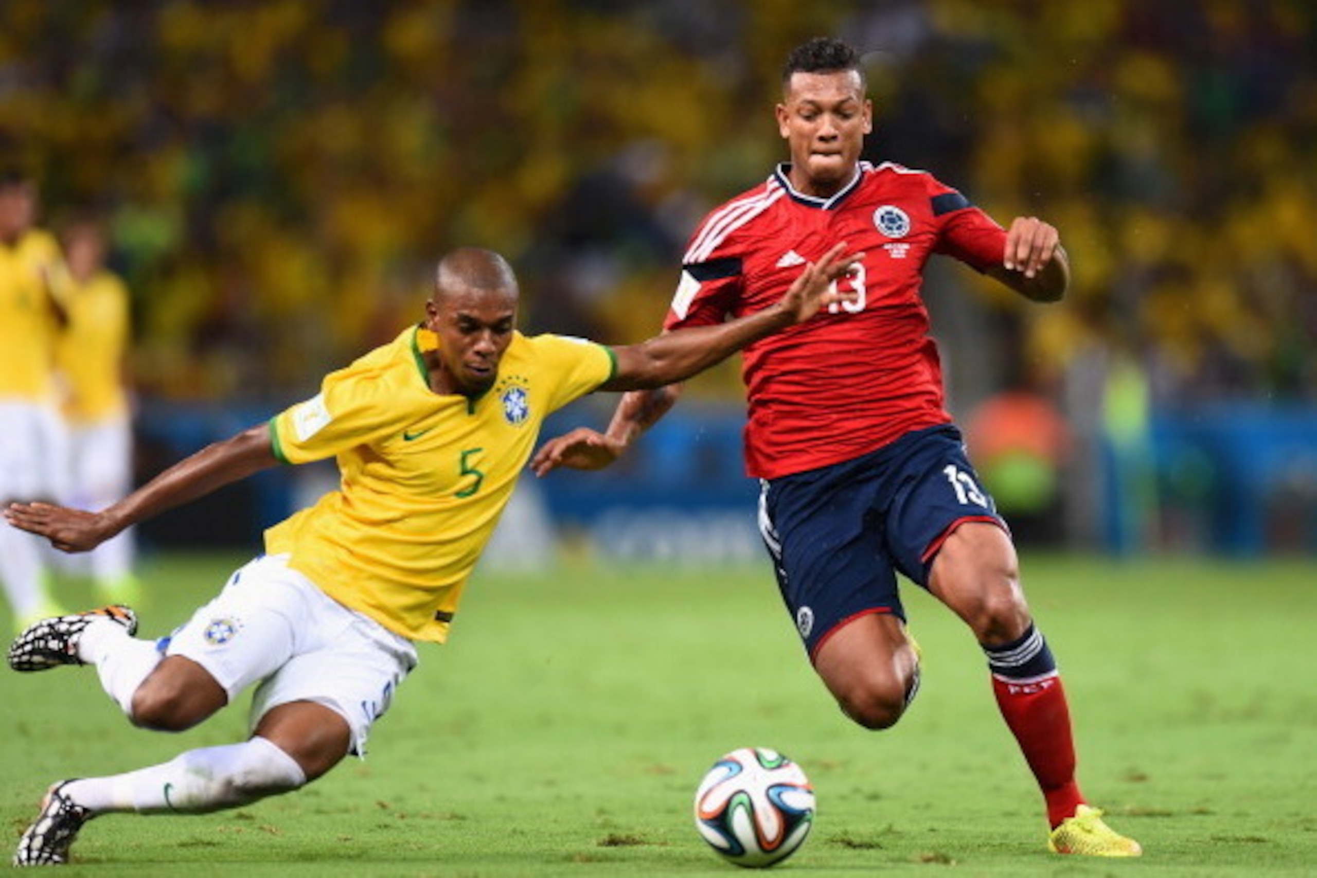 FORTALEZA, BRAZIL - JULY 04: Fernandinho of Brazil tackles Fredy Guarin of Colombia during the 2014 FIFA World Cup Brazil Quarter Final match between Brazil and Colombia at Castelao on July 4, 2014 in Fortaleza, Brazil. (Photo by Buda Mendes/Getty Image FORTALEZA, BRAZIL - JULY 04: Fernandinho of Brazil tackles Fredy Guarin of Colombia during the 2014 FIFA World Cup Brazil Quarter Final match between Brazil and Colombia at Castelao on July 4, 2014 in Fortaleza, Brazil. (Photo by Buda Mendes/Getty Image