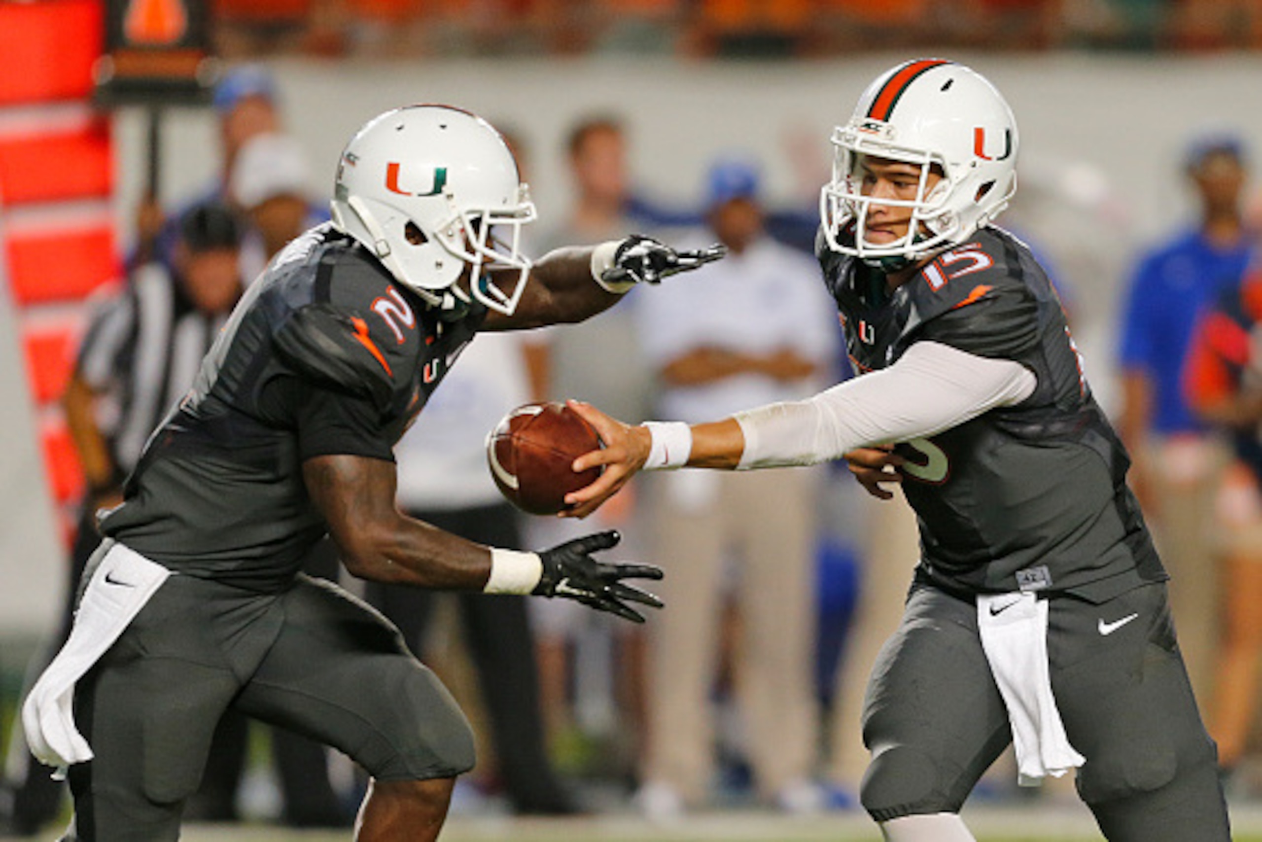 MIAMI GARDENS, FL - SEPTEMBER 27: Brad Kaaya #15 hands the ball off to Joseph Yearby #2 of the Miami Hurricanes against the Duke Blue Devils during first quarter action on September 27, 2014 at Sun Life Stadium in Miami Gardens, Florida.(Photo by Joel Aue