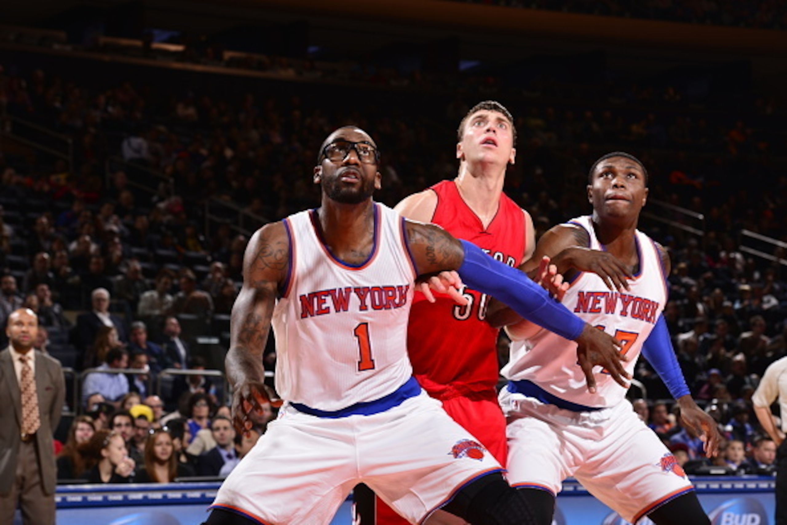 NEW YORK, NY - OCTOBER 13:  Amar'e Stoudemire #1 and Cleanthony Early #17 of the New York Knicks box out Tyler Hansbrough #50 of the Toronto Raptors during a game at Madison Square Garden on October 13, 2014 in New York City, New York. NOTE TO USER: User 