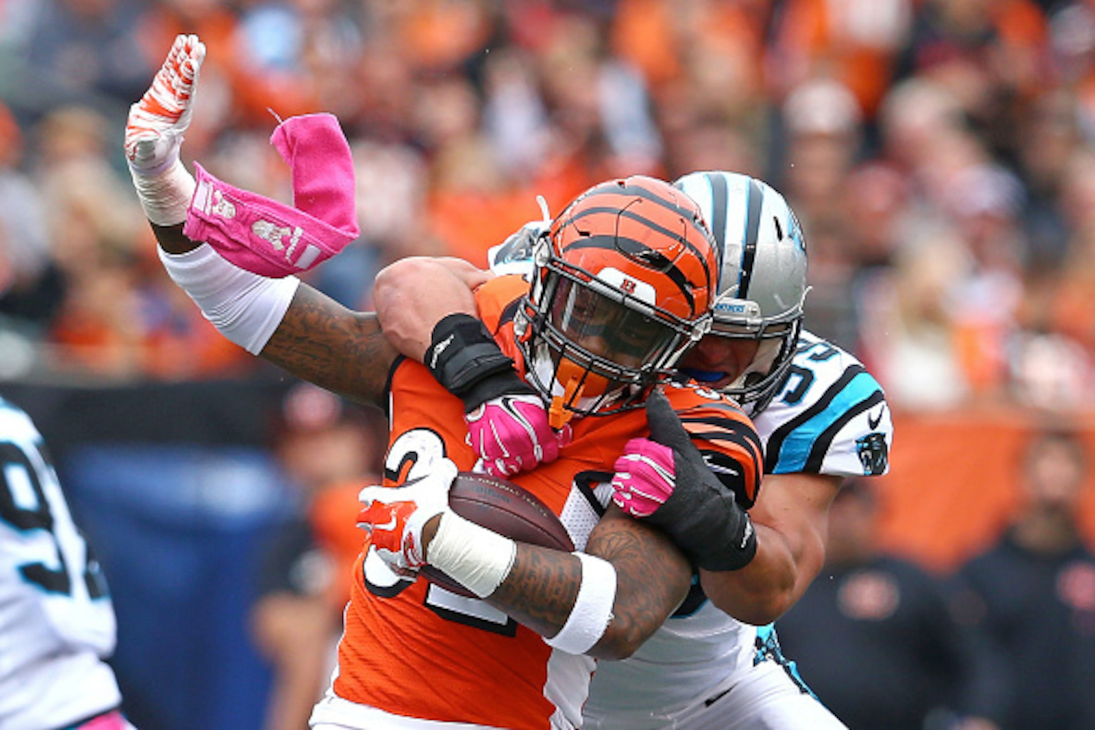 CINCINNATI, OH - OCTOBER 12:  Jeremy Hill #32 of the Cincinnati Bengals is tackled by Luke Kuechly #59 of the Carolina Panthers during the third quarter at Paul Brown Stadium on October 12, 2014 in Cincinnati, Ohio. (Photo by Andy Lyons/Getty Images)