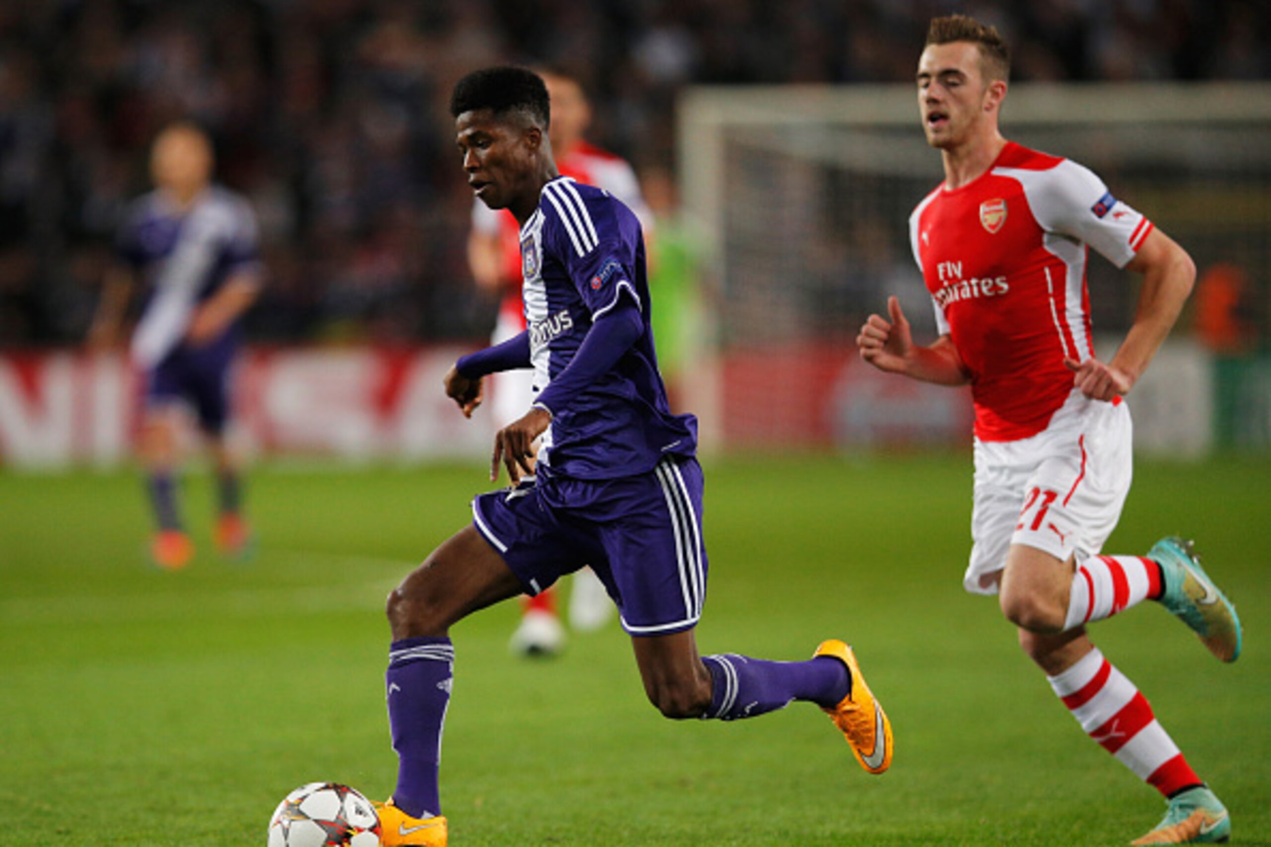 BRUSSELS, BELGIUM - OCTOBER 22:  Ibrahima Conte of Anderlecht is chased by Calum Chambers of Arsenal during the UEFA Champions League Group D match between RSC Anderlecht and Arsenal at Constant Vanden Stock Stadium on October 22, 2014 in Brussels, Belgiu