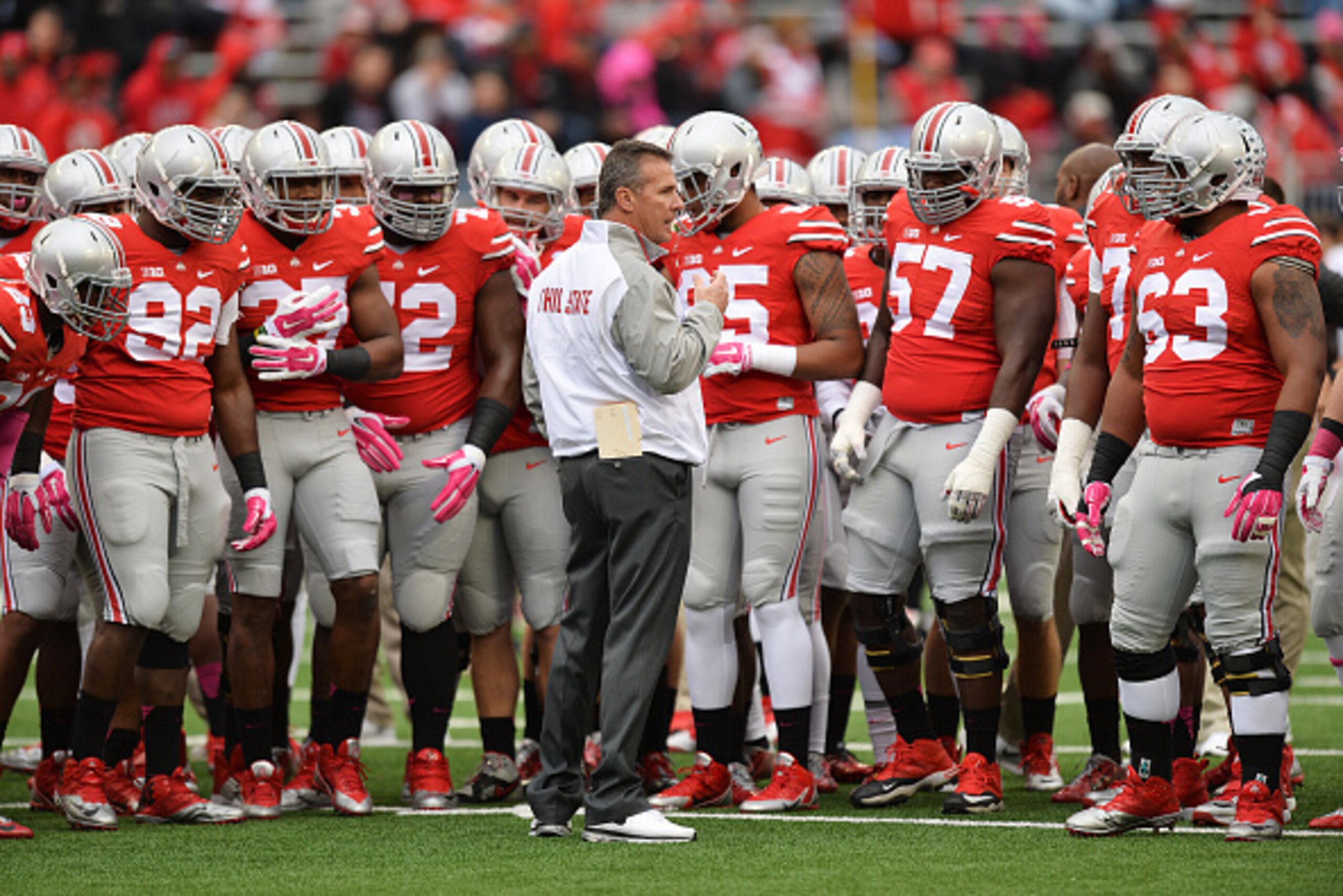 COLUMBUS, OH - OCTOBER 18:  Head Coach Urban Meyer of the Ohio State Buckeyes gathers his team at midfield before a game against the Rutgers Scarlet Knights on October 18, 2014 at Ohio Stadium in Columbus, Ohio.  (Photo by Jamie Sabau/Getty Images)