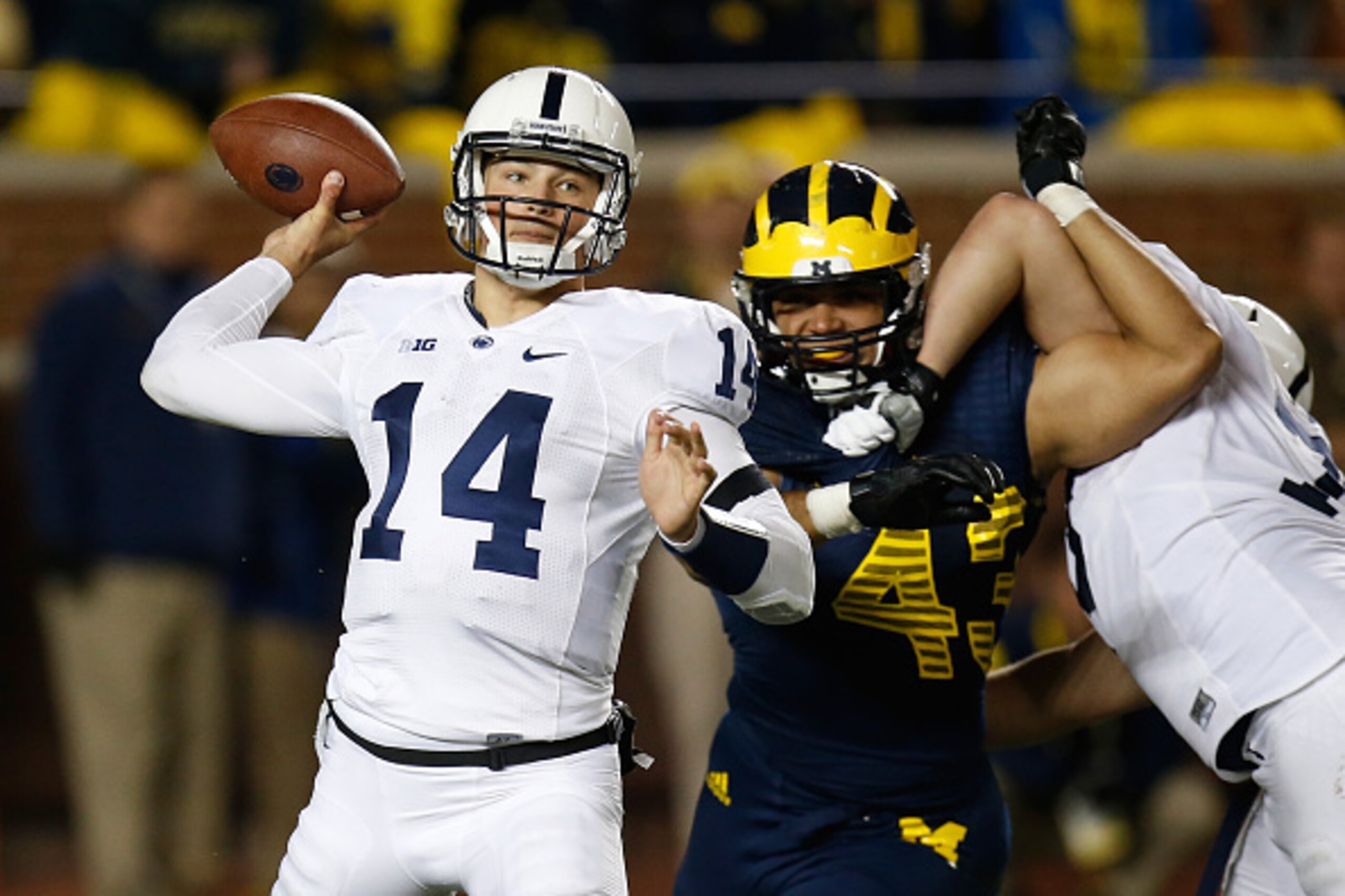 ANN ARBOR, MI - OCTOBER 11:  Christian Hackenberg #14 of the Penn State Nittany Lions throws a third quarter pass in front of Chris Wormley #43 of the Michigan Wolverines on October 11, 2014 at Michigan Stadium in Ann Arbor, Michigan. Michigan won the gam