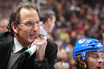 VANCOUVER, BC - APRIL 5:  Head coach John Tortorella of the Vancouver Canucks looks on from the bench during their NHL game against the Los Angeles Kings at Rogers Arena April 5, 2014 in Vancouver, British Columbia, Canada.  Vancouver won 2-1. (Photo by J