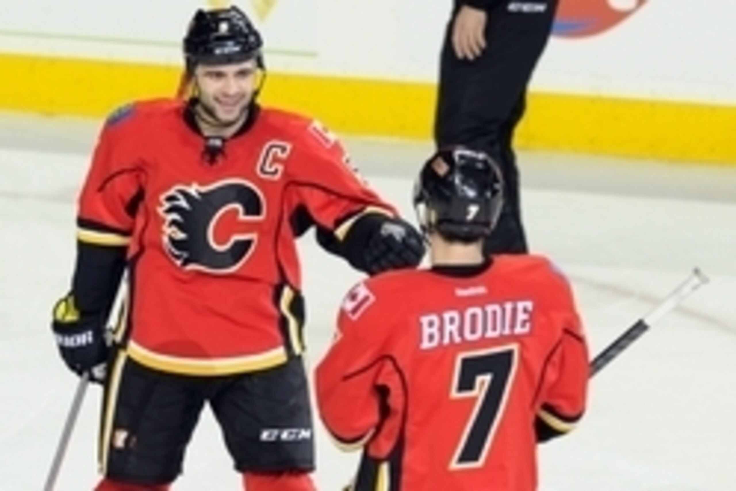 Dec 4, 2013; Calgary, Alberta, CAN; Calgary Flames defenseman Mark Giordano (5) and defensemand TJ Brodie (7) celebrate Giordano's goal against the Phoenix Coyotes during the second period at Scotiabank Saddledome. Mandatory Credit: Candice Ward-USA TODAY