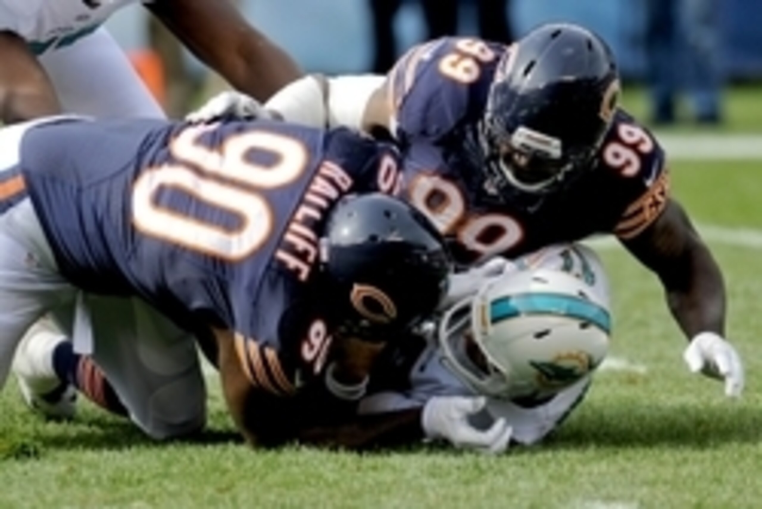Oct 19, 2014; Chicago, IL, USA; Chicago Bears defensive tackle Jeremiah Ratliff (90) and Chicago Bears defensive end Lamarr Houston (99) sack Miami Dolphins quarterback Ryan Tannehill (17) in the first quarter of their game at Soldier Field. Mandatory Cre Oct 19, 2014; Chicago, IL, USA; Chicago Bears defensive tackle Jeremiah Ratliff (90) and Chicago Bears defensive end Lamarr Houston (99) sack Miami Dolphins quarterback Ryan Tannehill (17) in the first quarter of their game at Soldier Field. Mandatory Cre