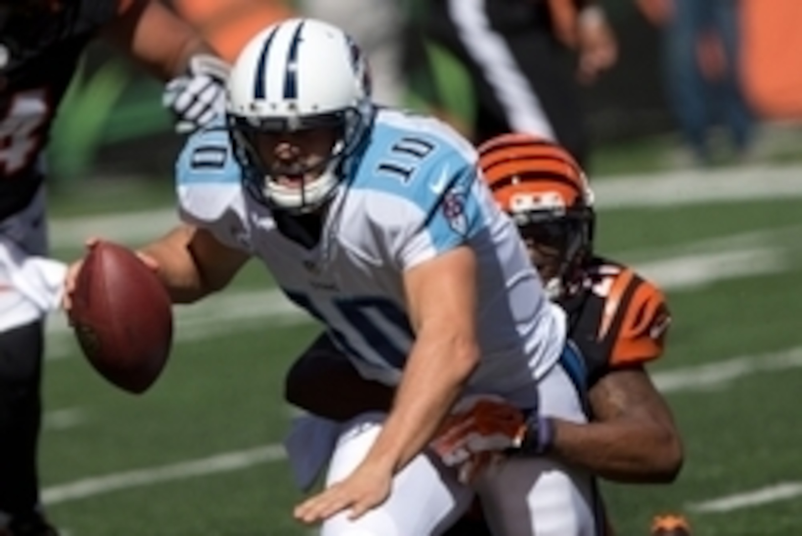Sep 21, 2014; Cincinnati, OH, USA; Tennessee Titans quarterback Jake Locker (10) is sacked by Cincinnati Bengals cornerback Darqueze Dennard (21) at Paul Brown Stadium. The Bengals won 33-7. Mandatory Credit: Aaron Doster-USA TODAY Sports