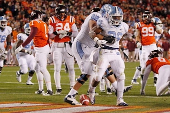 BLACKSBURG, VIRGINIA - NOVEMBER 17:  Running back Giovani Bernard #26 of the North Carolina Tar Heels celebrates with defensive tackle James Hurst #68 of the Tar Heels after scoring a touchdown against the Virginia Tech Hokies at Lane Stadium on November 