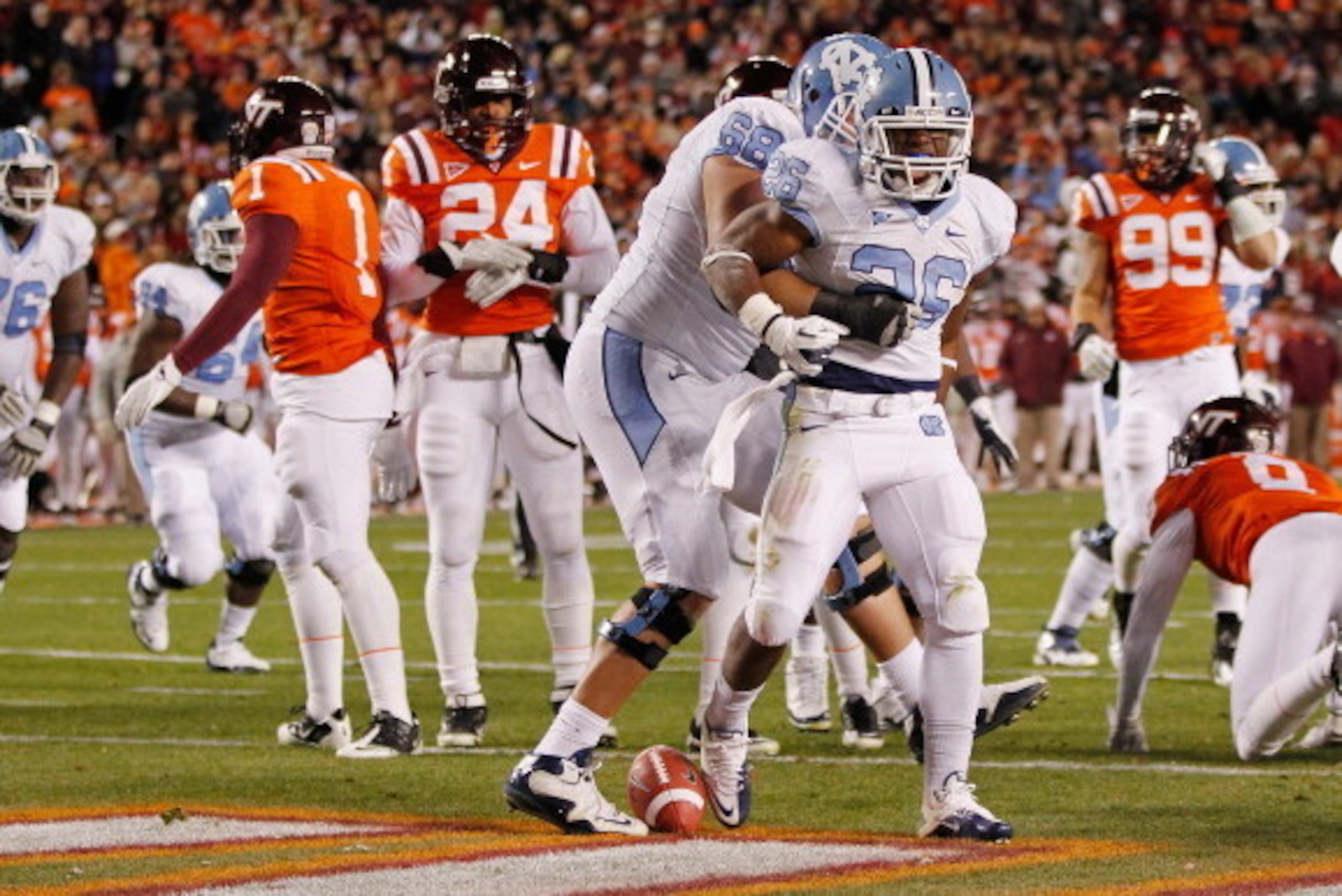 BLACKSBURG, VIRGINIA - NOVEMBER 17:  Running back Giovani Bernard #26 of the North Carolina Tar Heels celebrates with defensive tackle James Hurst #68 of the Tar Heels after scoring a touchdown against the Virginia Tech Hokies at Lane Stadium on November 