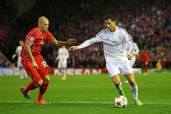 LIVERPOOL, ENGLAND - OCTOBER 22:  Cristiano Ronaldo of Real Madrid competes with Martin Skrtel of Liverpool  during the UEFA Champions League Group B match between Liverpool and Real Madrid CF on October 22, 2014 in Liverpool, United Kingdom.  (Photo by A