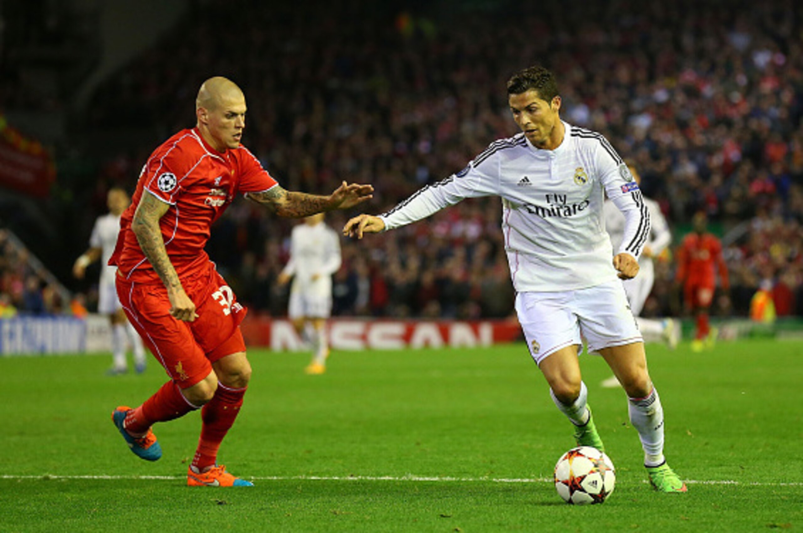 LIVERPOOL, ENGLAND - OCTOBER 22:  Cristiano Ronaldo of Real Madrid competes with Martin Skrtel of Liverpool  during the UEFA Champions League Group B match between Liverpool and Real Madrid CF on October 22, 2014 in Liverpool, United Kingdom.  (Photo by A