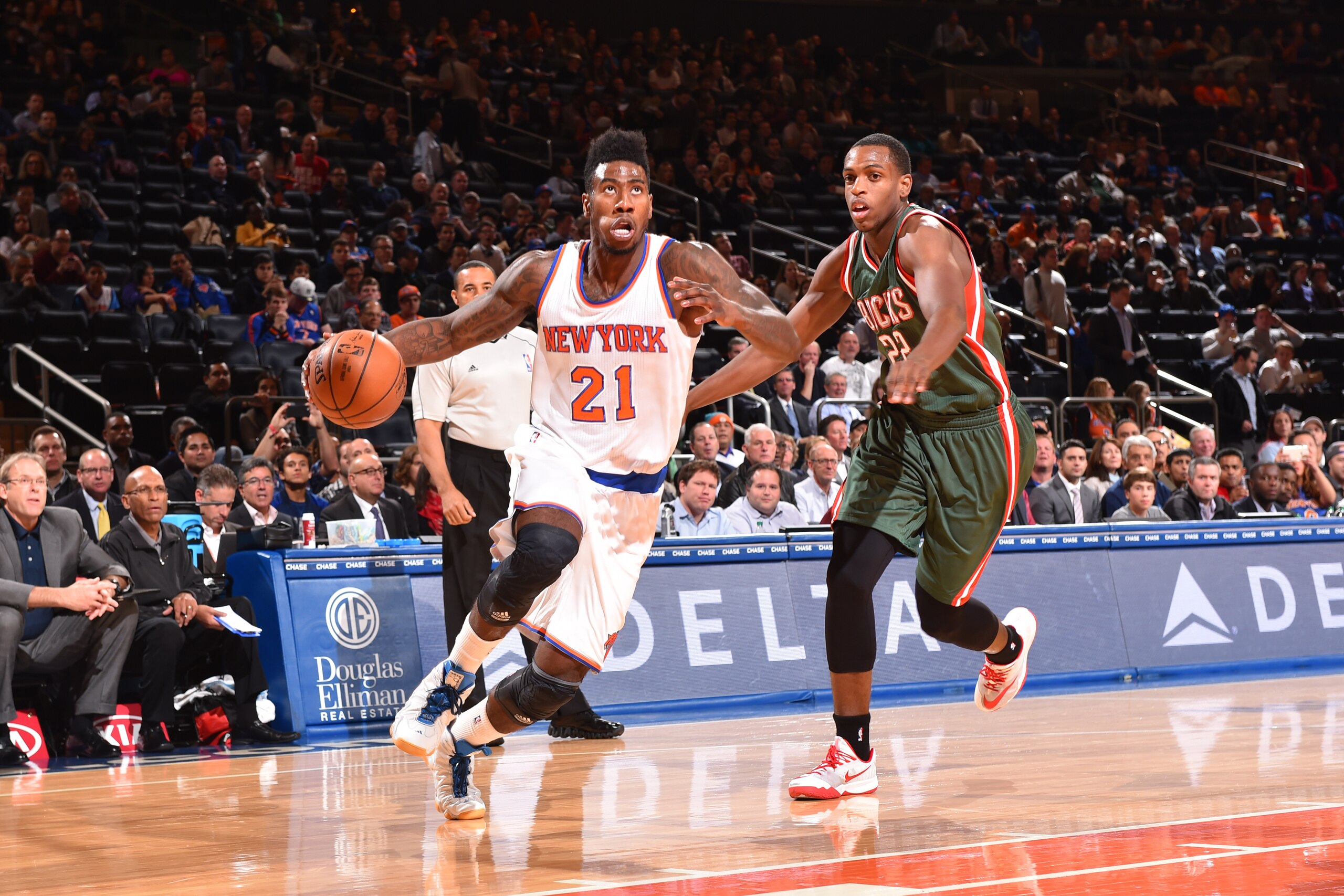 NEW YORK, NY - OCTOBER 20:  Iman Shumpert #21 of the New York Knicks dribbles against Khris Middleton #22 of the Milwaukee Bucks on October 20, 2014 at Madison Square Garden in New York City. NOTE TO USER: User expressly acknowledges and agrees that, by d
