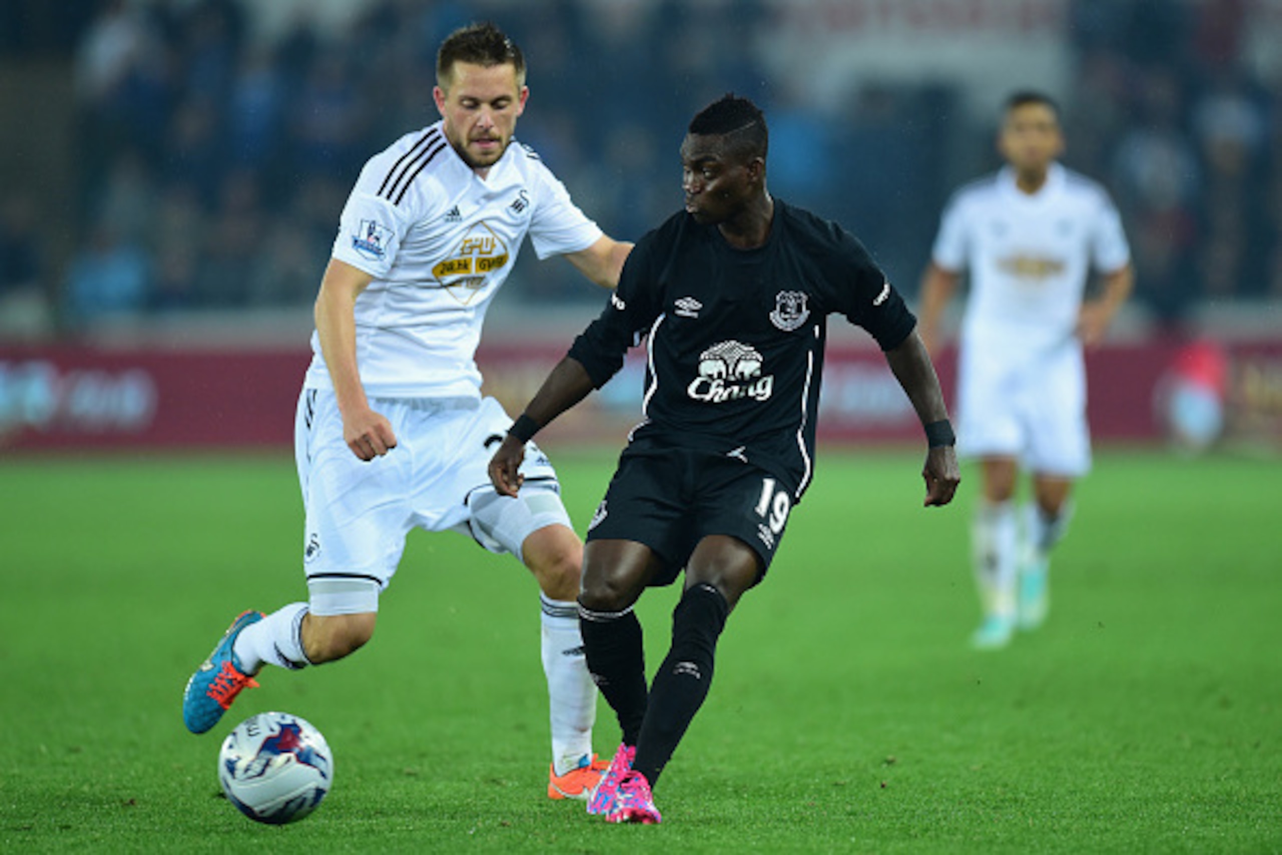 SWANSEA, WALES - SEPTEMBER 23: Swansea player Gylfi Sigurdsson (l) challenges Christian Atsu during the Capital One Cup Third Round match between Swansea City and Everton at Liberty Stadium on September 23, 2014 in Swansea, Wales. (Photo by Stu Forster/ SWANSEA, WALES - SEPTEMBER 23: Swansea player Gylfi Sigurdsson (l) challenges Christian Atsu during the Capital One Cup Third Round match between Swansea City and Everton at Liberty Stadium on September 23, 2014 in Swansea, Wales. (Photo by Stu Forster/