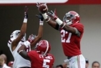 Oct 18, 2014; Tuscaloosa, AL, USA; Alabama Crimson Tide defensive back Nick Perry (27) goes up for the ball along with Texas A&M Aggies Edward Pope (18) at Bryant-Denny Stadium. The Crimson Tide defeated the Aggies 59-0. Mandatory Credit: Marvin Gentry-US