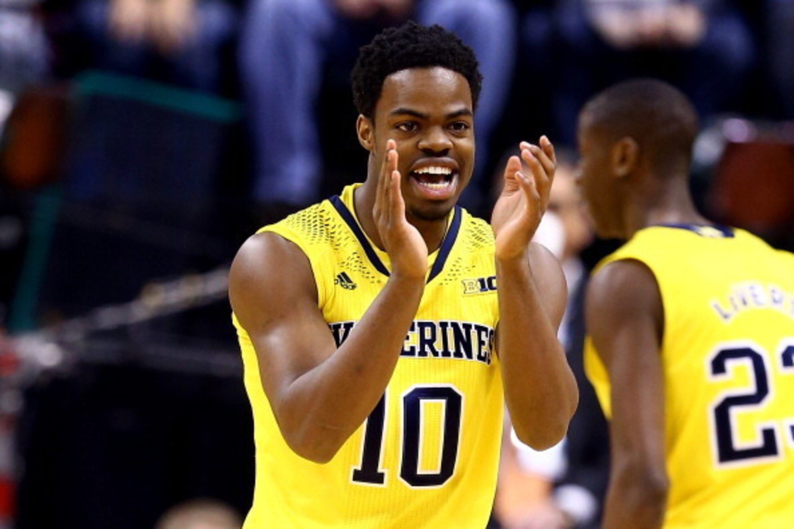 INDIANAPOLIS, IN - MARCH 16:  Derrick Walton Jr. #10 of the Michigan Wolverines reacts against the Michigan State Spartans during the 2014 Big Ten Men's Championship at Bankers Life Fieldhouse on March 16, 2014 in Indianapolis, Indiana.  (Photo by Andy Ly