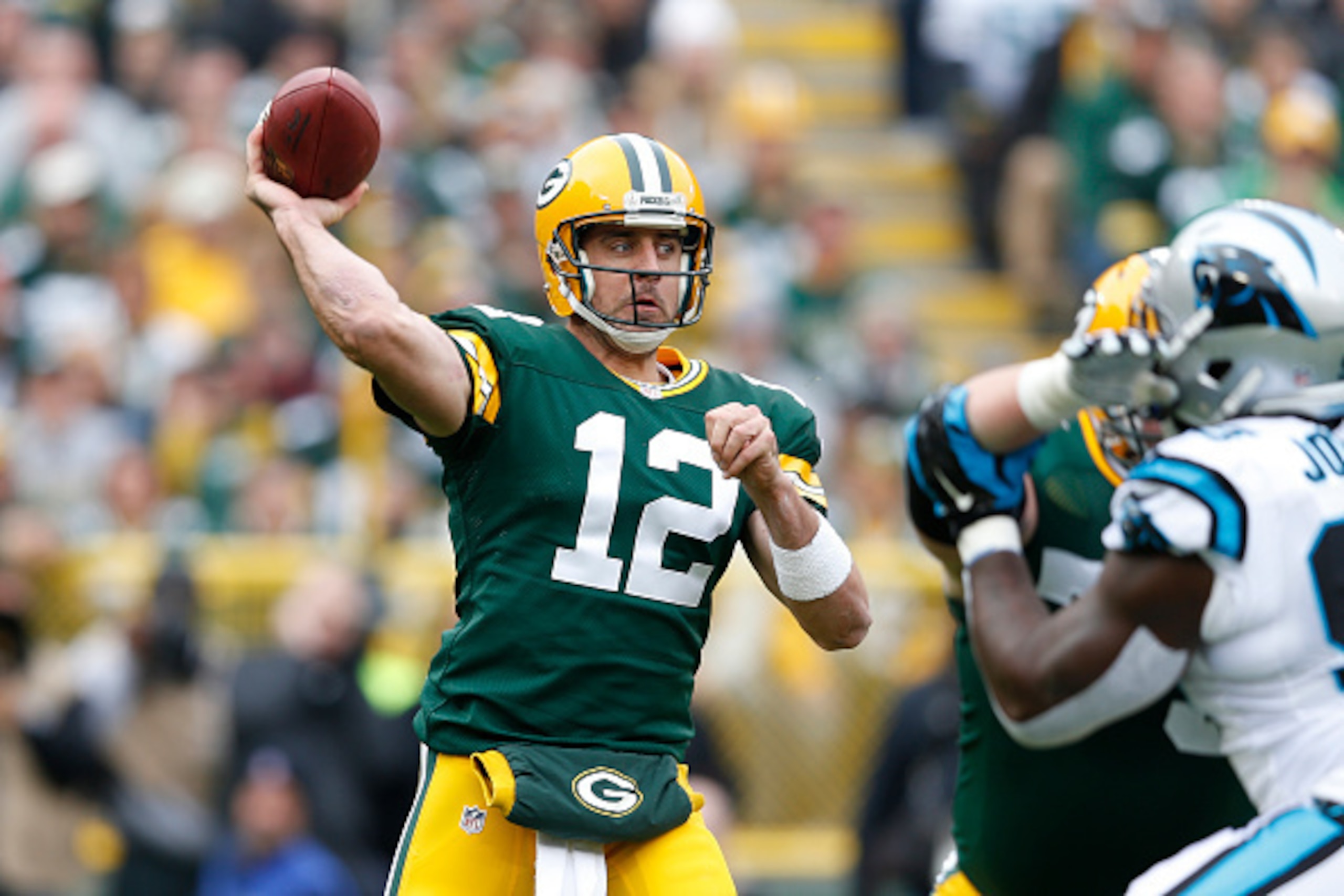 GREEN BAY, WI - OCTOBER 19:  Aaron Rodgers #12 of the Green Bay Packers passes the ball in the first half of the game against the Carolina Panthers at Lambeau Field on October 19, 2014 in Green Bay, Wisconsin. (Photo by Joe Robbins/Getty Images)