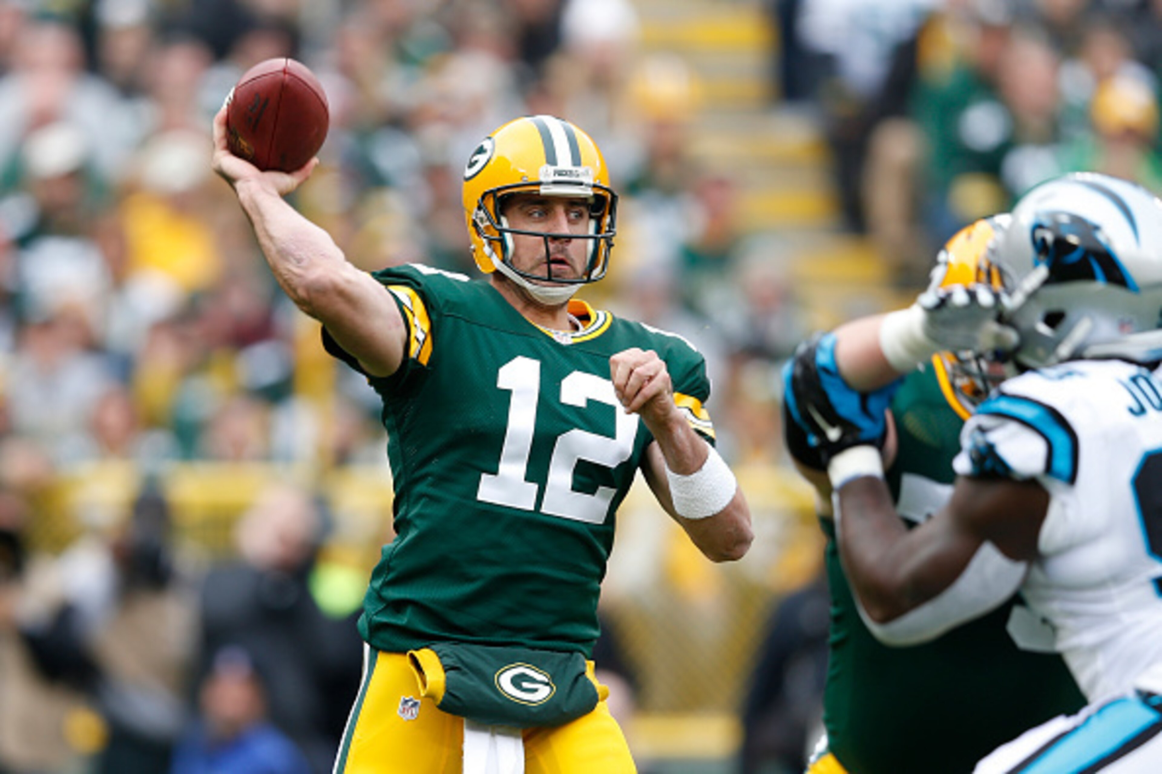GREEN BAY, WI - OCTOBER 19:  Aaron Rodgers #12 of the Green Bay Packers passes the ball in the first half of the game against the Carolina Panthers at Lambeau Field on October 19, 2014 in Green Bay, Wisconsin. (Photo by Joe Robbins/Getty Images)