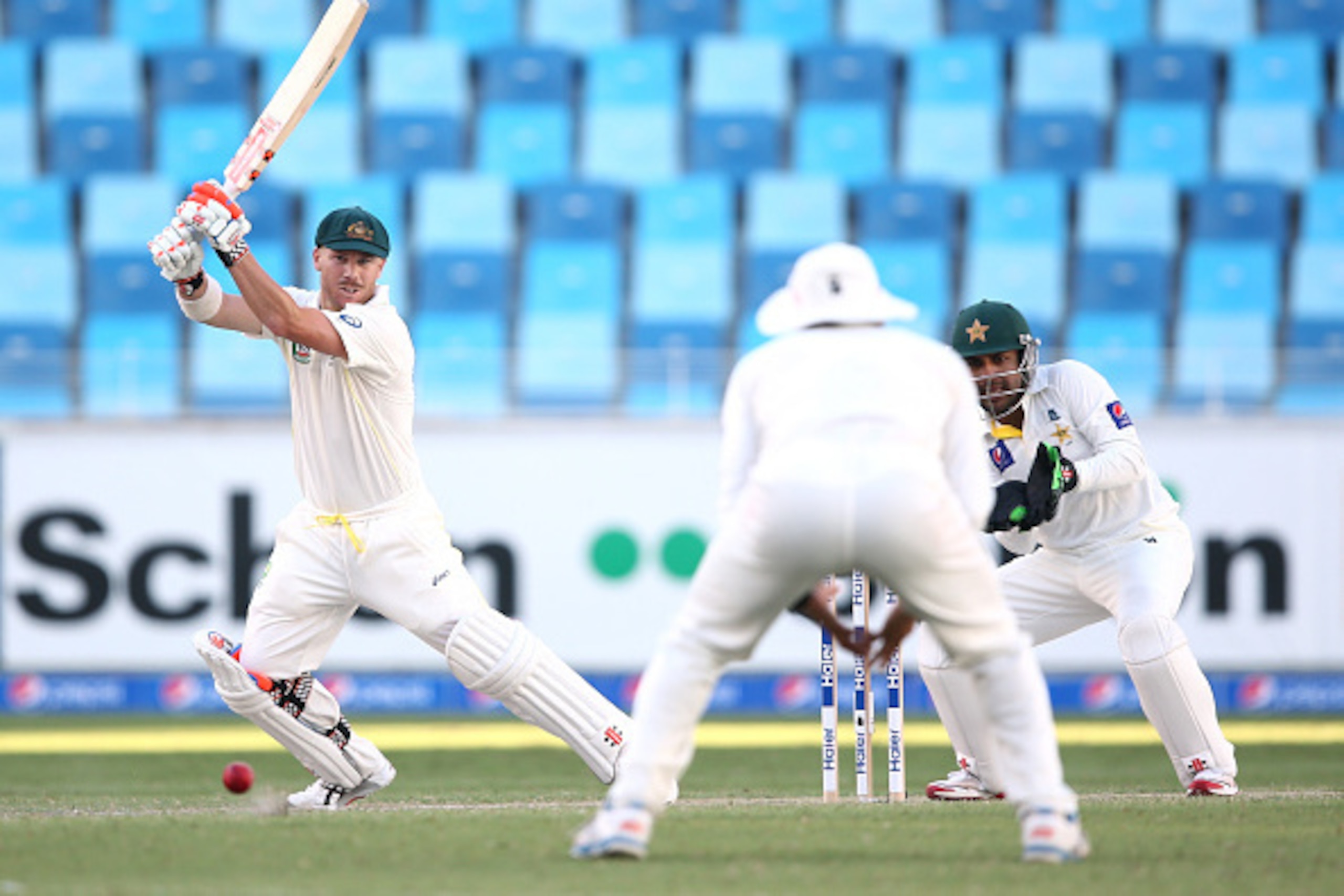 DUBAI, UNITED ARAB EMIRATES - OCTOBER 23:  David Warner of Australia plays the ball during Day Two of the First Test between Pakistan and Australia at Dubai International Stadium at Dubai International Stadium on October 23, 2014 in Dubai, United Arab Emi