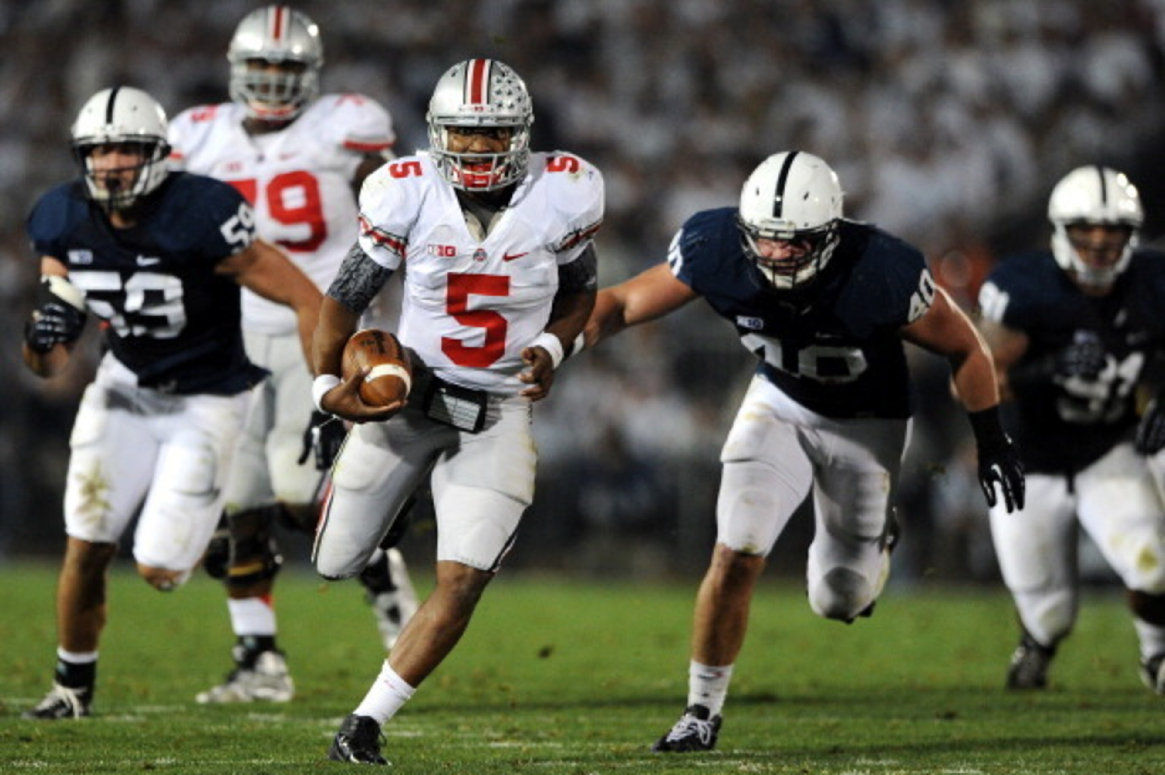 STATE COLLEGE, PA - OCTOBER 27: Quarterback Braxton Miller #5 of the Ohio State Buckeyes rushes past linebacker Glenn Carson #40 of the Penn State Nittany Lions in the second quarter at Beaver Stadium on October 27, 2012 in State College, Pennsylvania. (P