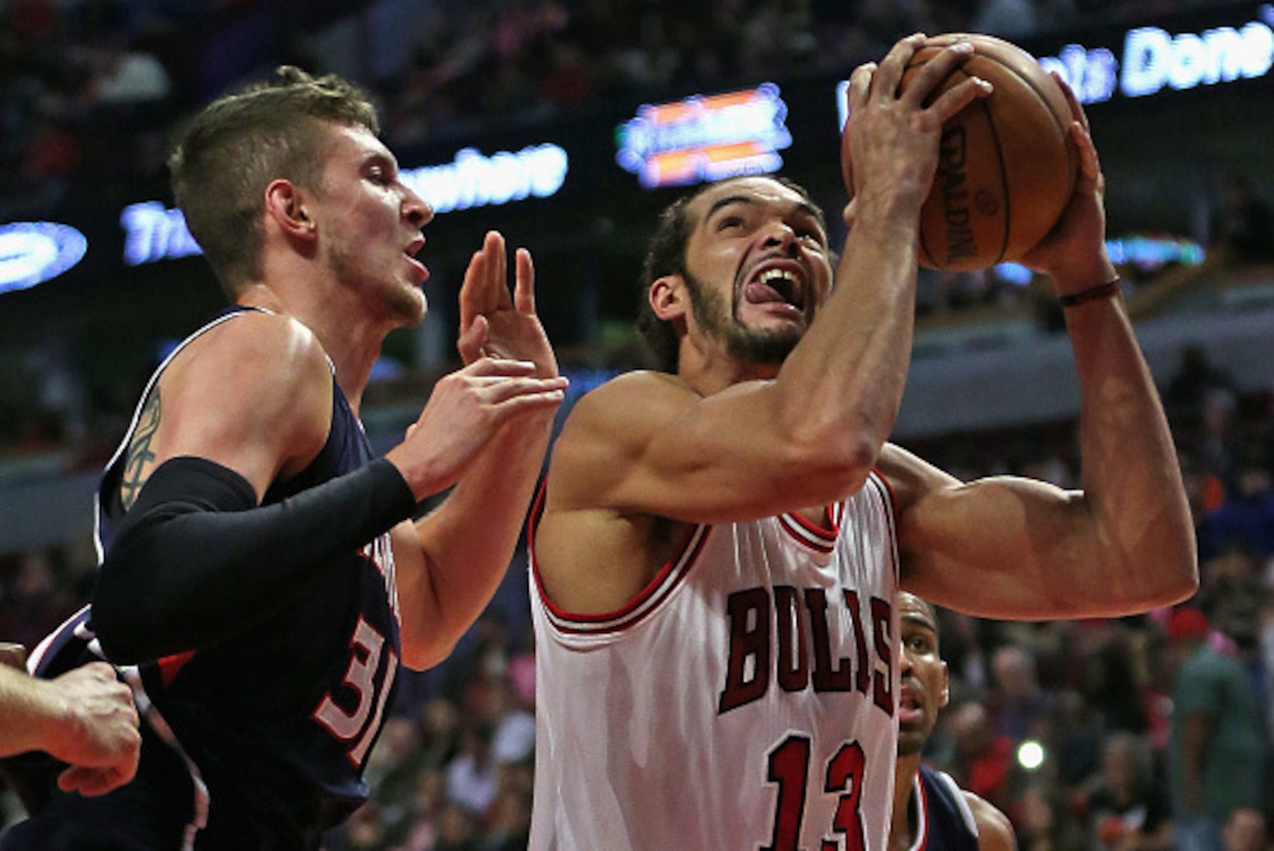 CHICAGO, IL - OCTOBER 16: Joakim Noah #13 of the Chicago Bullsshoots against Mike Muscala #31 of the Atlanta Hawks during a preseason game at the United Center on October 16, 2014 in Chicago, Illinois. NOTE TO USER: User expressly acknowledges and agrees 