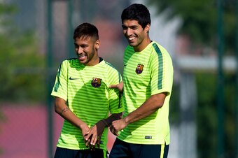 BARCELONA, SPAIN - OCTOBER 20:  Neymar (L) and Luis Suarez of FC Barcelona  share a joke during a training session ahead of their UEFA Champions League Group F match against AFC Ajax at Ciutat Esportiva on October 20, 2014 in Barcelona, Spain.  (Photo by 
