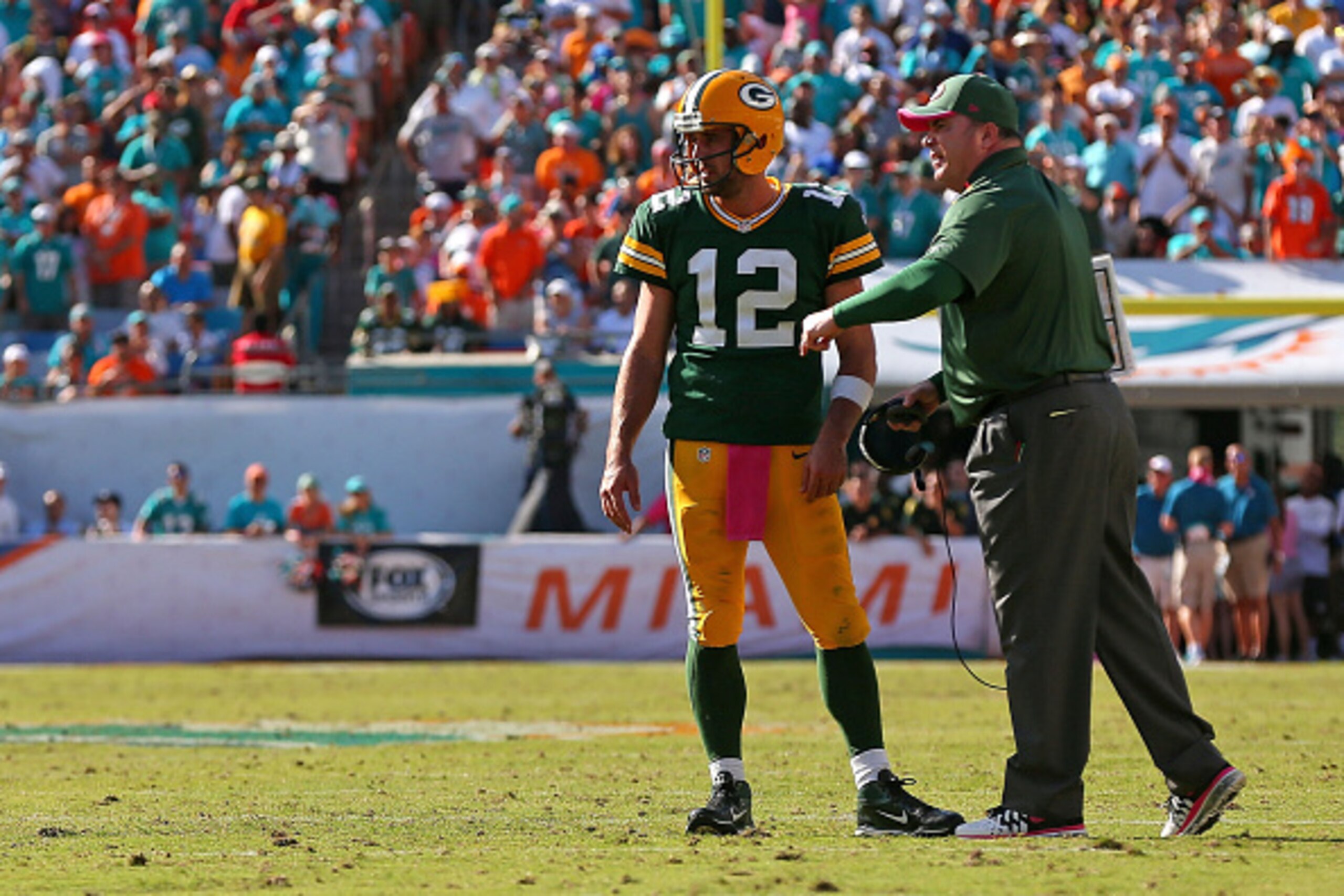 MIAMI GARDENS, FL - OCTOBER 12: Aaron Rodgers #12 of the Green Bay Packers talks with head coach Mike McCarthy before the final play during a game against the Miami Dolphins at Sun Life Stadium on October 12, 2014 in Miami Gardens, Florida.  (Photo by Mik