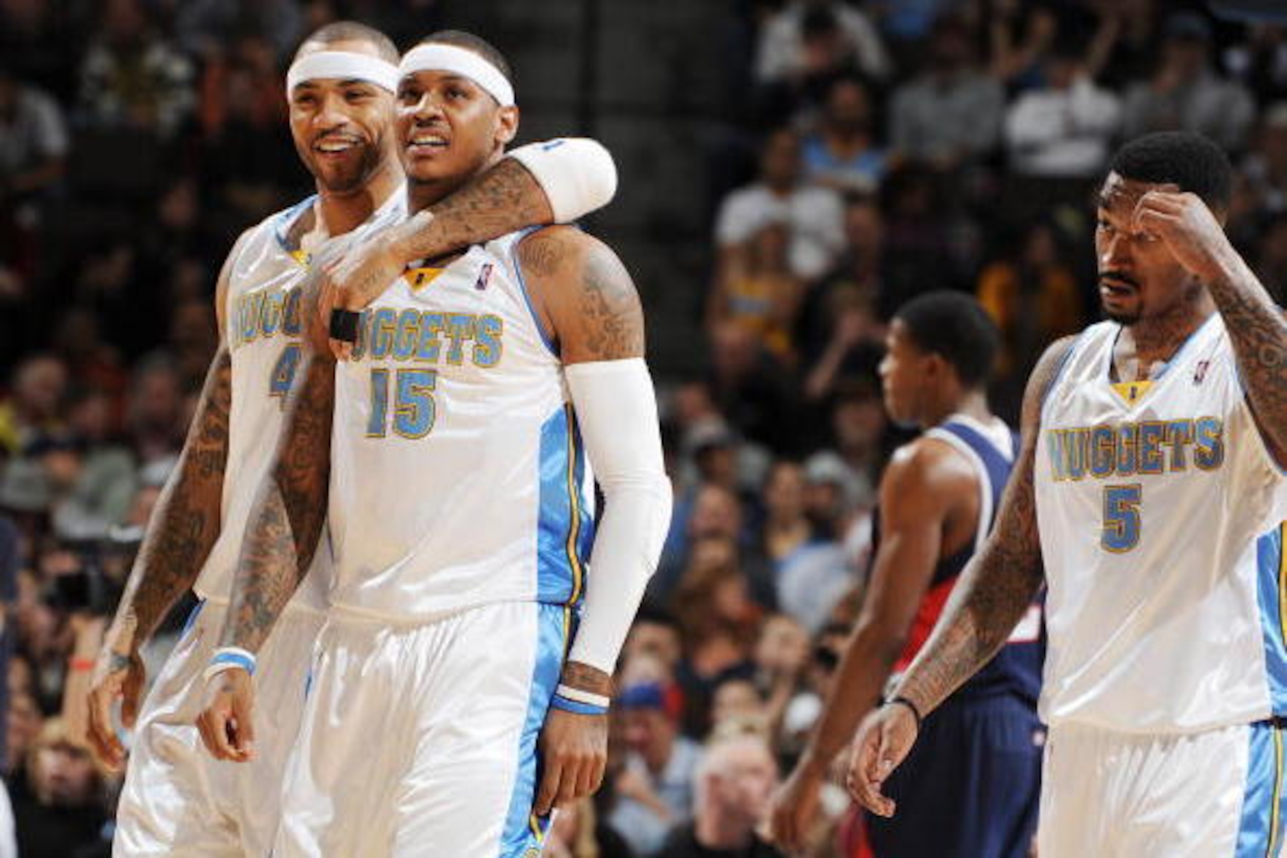 DENVER - DECEMBER 23: Kenyon Martin #4 and Carmelo Anthony #15 of the Denver Nuggets walk off the court during a time out  against the Atlanta Hawks on December 23, 2009 at the Pepsi Center in Denver, Colorado. NOTE TO USER: User expressly acknowledges an