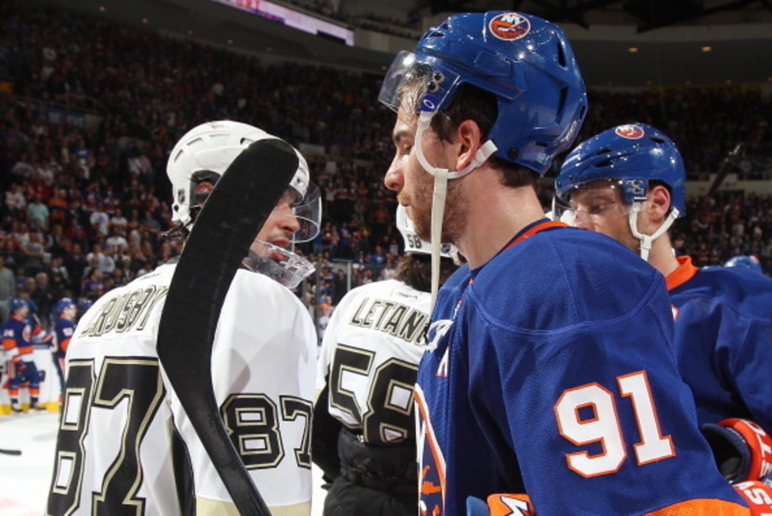 UNIONDALE, NY - MAY 11: John Tavares #91 of the New York Islanders shakes hands with Sidney Crosby #87 of the Pittsburgh Penguins in Game Six of the Eastern Conference Quarterfinals during the 2013 NHL Stanley Cup Playoffs at Nassau Veterans Memorial Coli