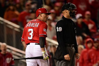 WASHINGTON, DC - OCTOBER 04:  Asdrubal Cabrera #3 of the Washington Nationals argues a stike call with home plate umpire Vic Carapazza in the tenth inning against Jeremy Affeldt #41 of the San Francisco Giants during Game Two of the National League Divisi
