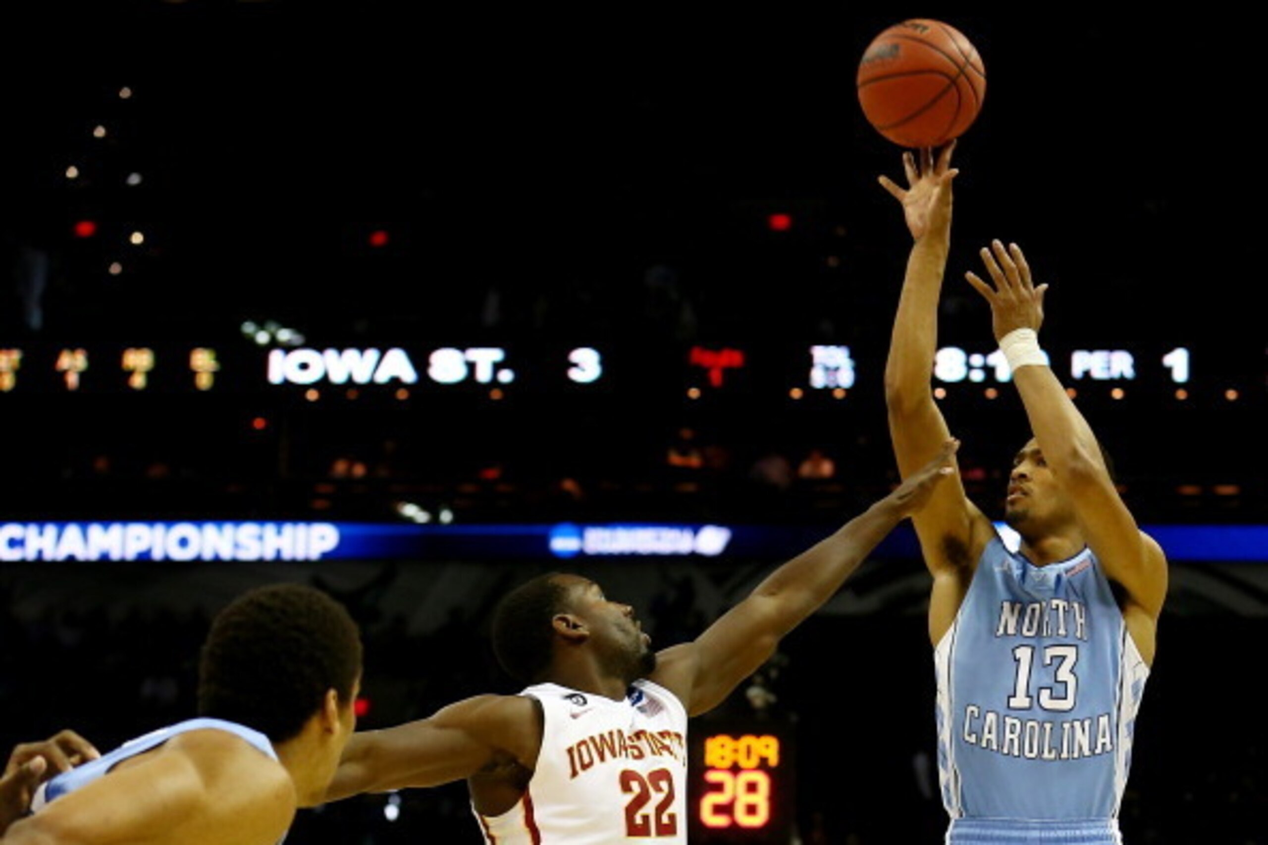 SAN ANTONIO, TX - MARCH 23: J.P. Tokoto #13 of the North Carolina Tar Heels takes a shot over Dustin Hogue #22 of the Iowa State Cyclones during the third round of the 2014 NCAA Men's Basketball Tournament at the AT&T Center on March 23, 2014 in San Anton