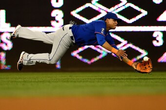 WASHINGTON, DC - AUGUST 05: Juan Lagares #12 of the New York Mets makes a catch on Denard Span #2 of the Washington Nationals (not pictured) in the seventh inning at Nationals Park on August 5, 2014 in Washington, DC. The New York Mets won, 6-1. (Photo by