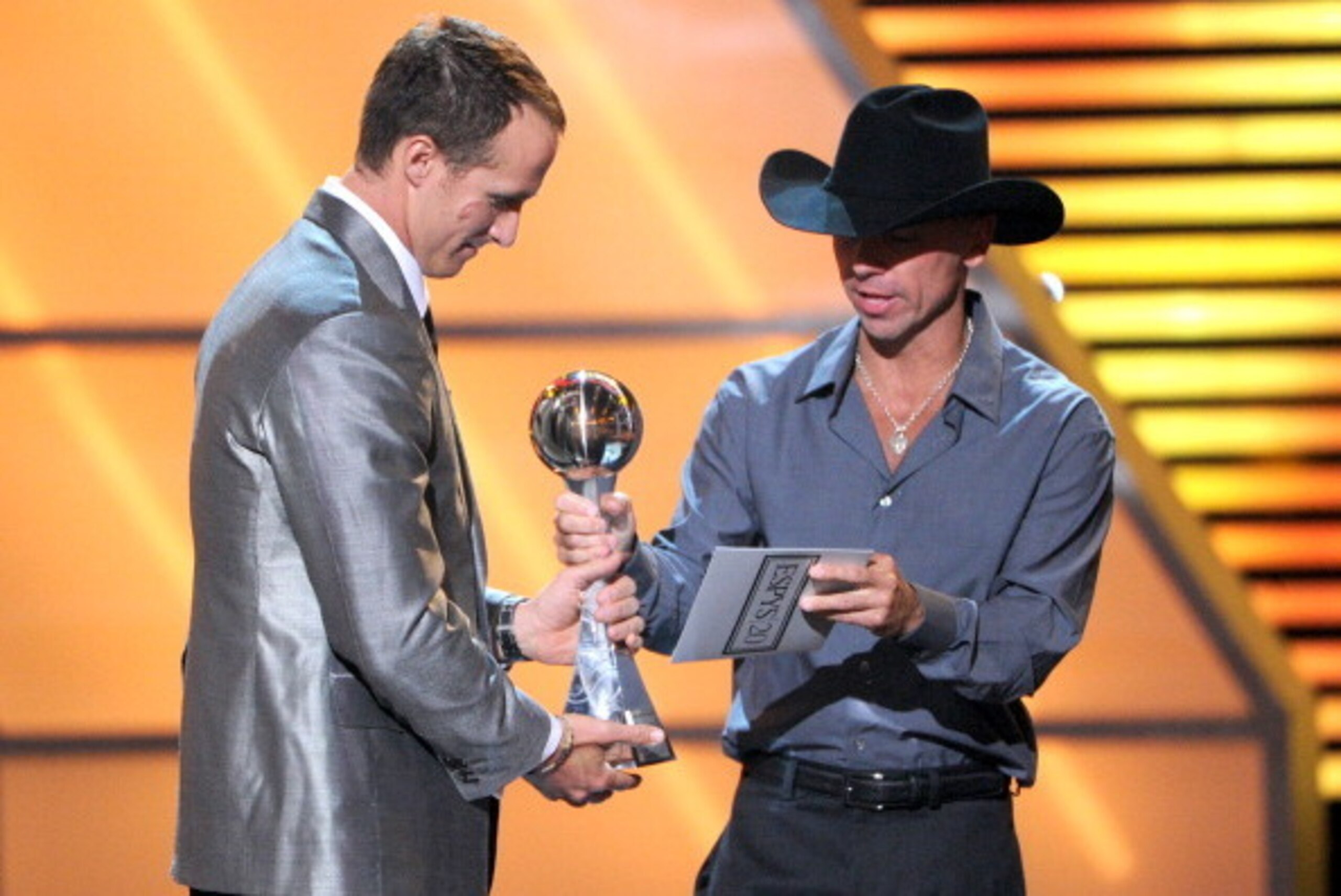 LOS ANGELES, CA - JULY 11:  NFL player Drew Brees of the New Orleans Saints accepts the Best Record-Breaking Performance award from musician Kenny Chesney onstage during the 2012 ESPY Awards at Nokia Theatre L.A. Live on July 11, 2012 in Los Angeles, Cali
