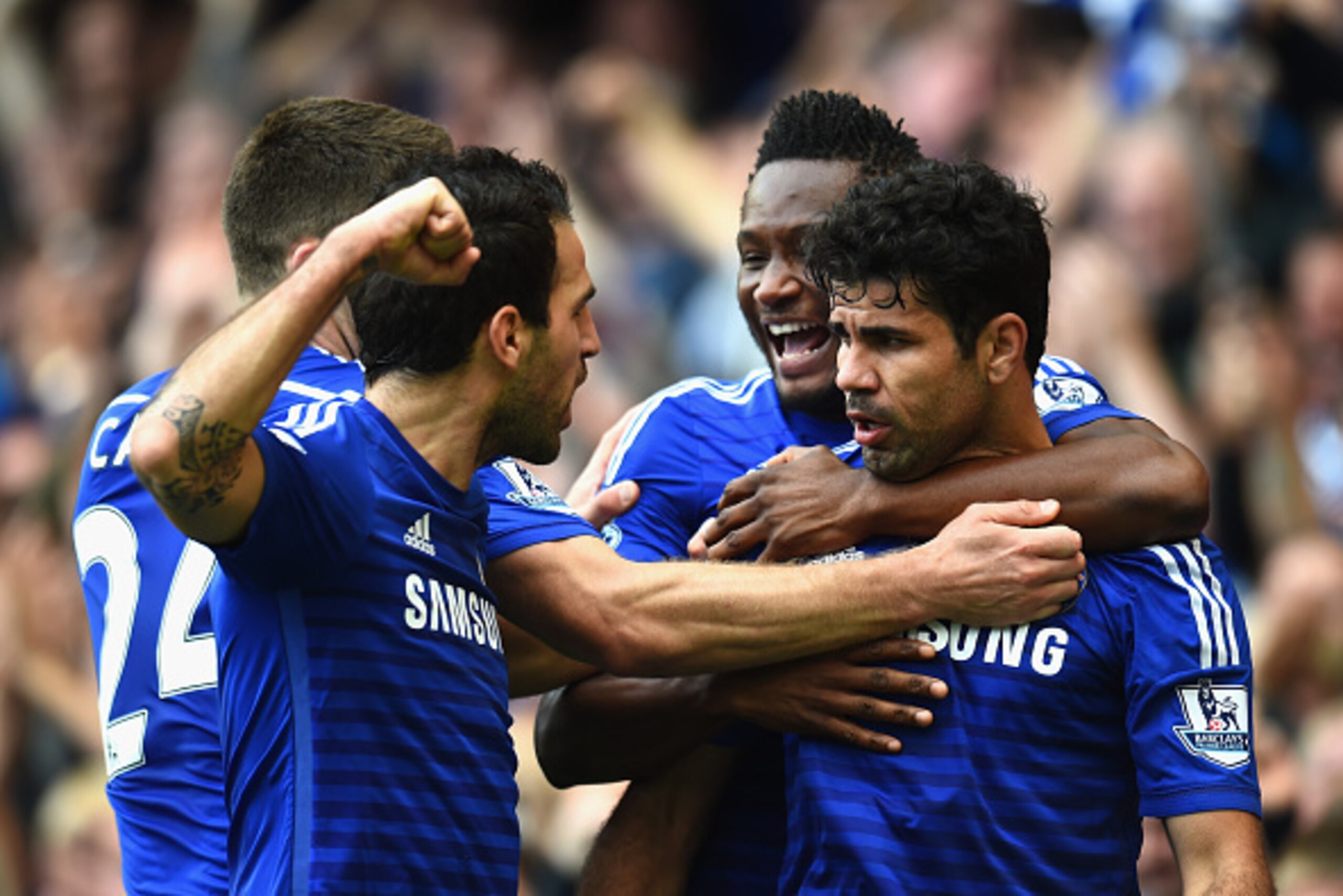 LONDON, ENGLAND - OCTOBER 05:  Diego Costa of Chelsea celebrates scoring their second goal with John Obi Mikel and Cesc Fabregas of Chelsea during the Barclays Premier League match between Chelsea and Arsenal at Stamford Bridge on October 4, 2014 in Londo