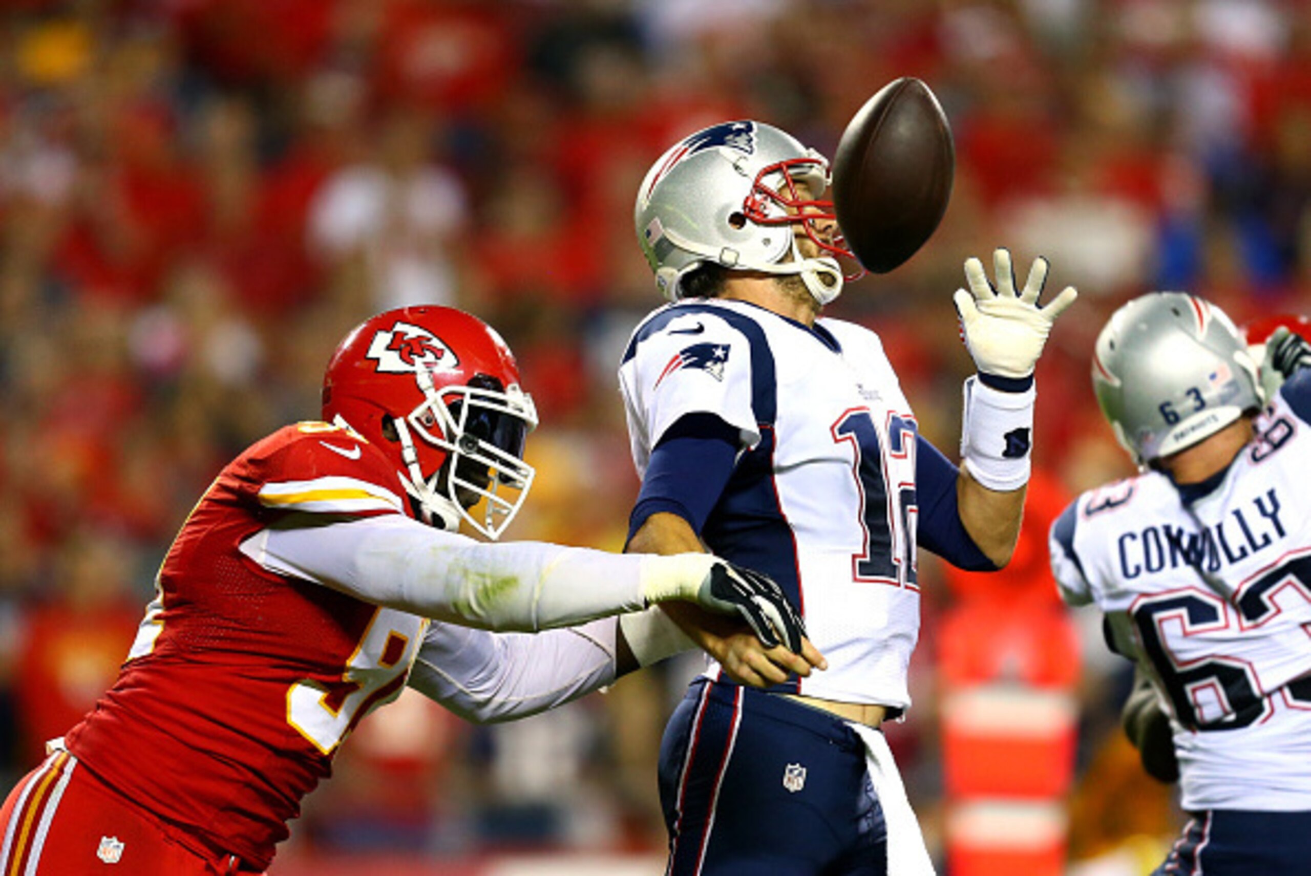 KANSAS CITY, MO - SEPTEMBER 29:  Tamba Hali #91 of the Kansas City Chiefs knocks the ball loose from Tom Brady #12 of the New England Patriots for a fumble during the third quarter at Arrowhead Stadium on September 29, 2014 in Kansas City, Missouri.  (Pho