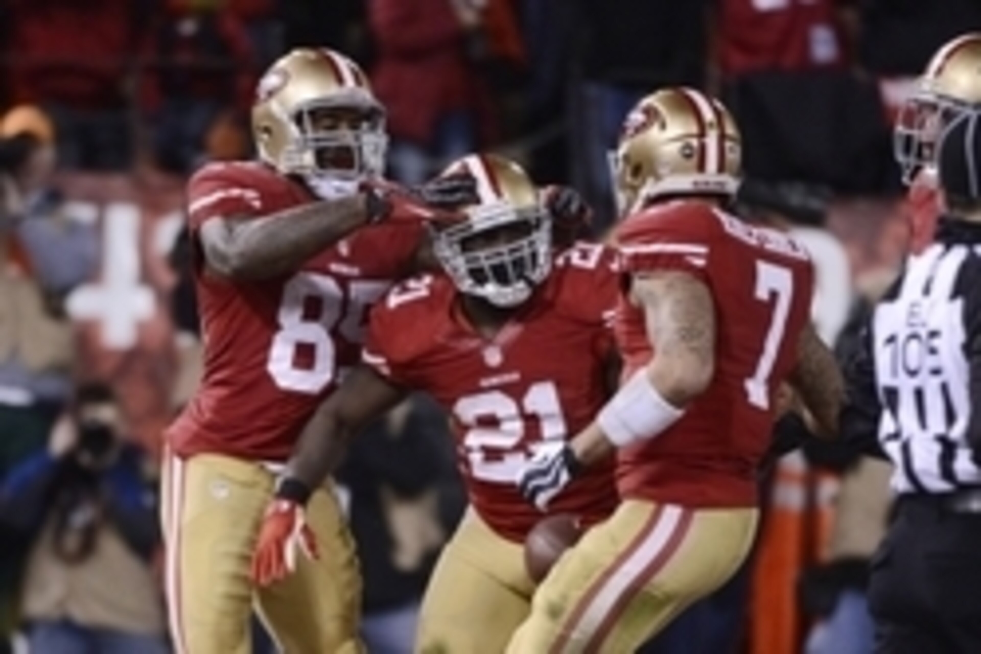 Jan 12, 2013; San Francisco, CA, USA; San Francisco 49ers running back Frank Gore (21) is congratulated by tight end Vernon Davis (85) and quarterback Colin Kaepernick (7) for scoring a touchdown against the Green Bay Packers during the third quarter of t