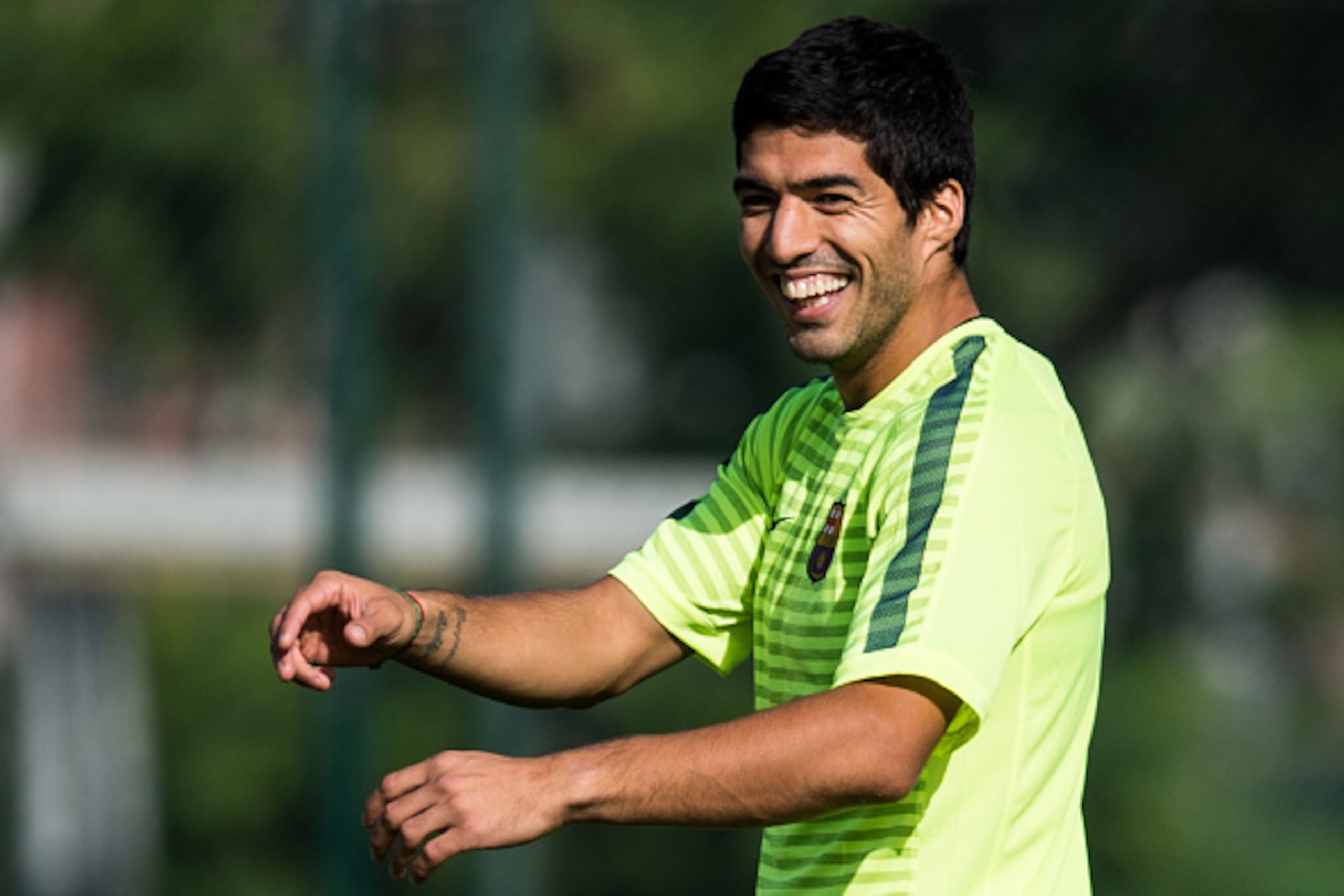 BARCELONA, SPAIN - OCTOBER 20:  Luis Suarez of FC Barcelona smiles during a training session ahead of their UEFA Champions League Group F match against AFC Ajax at Ciutat Esportiva on October 20, 2014 in Barcelona, Spain.  (Photo by David Ramos/Getty Imag