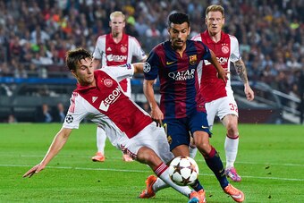 BARCELONA, SPAIN - OCTOBER 21: Pedro Rodriguez of FC Barcelona competes for the ball with Joel Veltman of AFC Ajax during a UEFA Champions League Group F match between FC Barcelona and AFC Ajax at the Camp Nou Stadium on October 21, 2014 in Barcelona, Spa